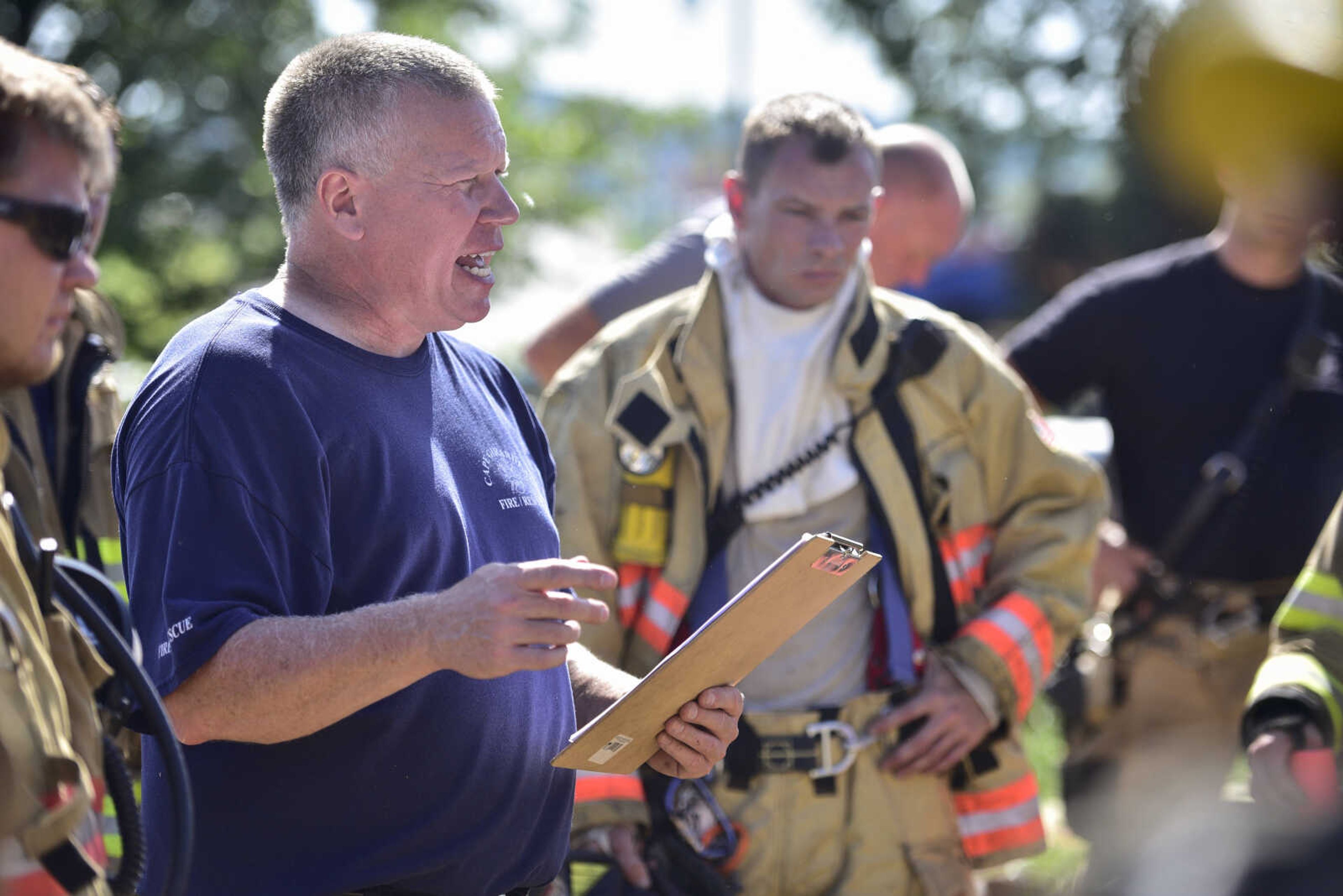 Cape Girardeau Fire Department battalion chief Mike Ramsey assigns firefighters to teams for exercises during live-fire training June 10, 2017 in Cape Girardeau.