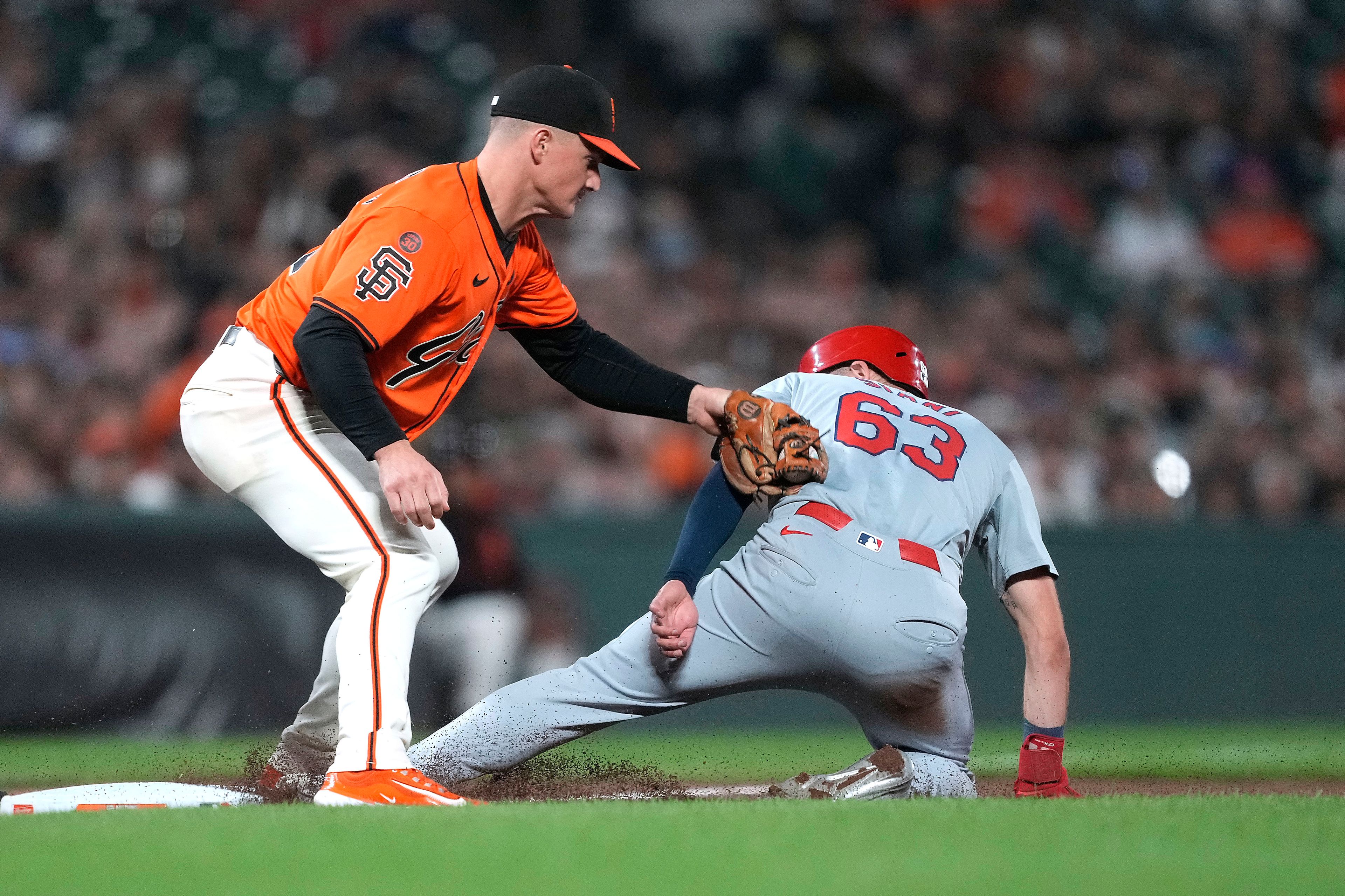 St. Louis Cardinals' Michael Siani (63) is tagged out at third base by San Francisco Giants third baseman Matt Chapman, left, during the eighth inning of a baseball game, Friday, Sept. 27, 2024, in San Francisco. (AP Photo/Tony Avelar)