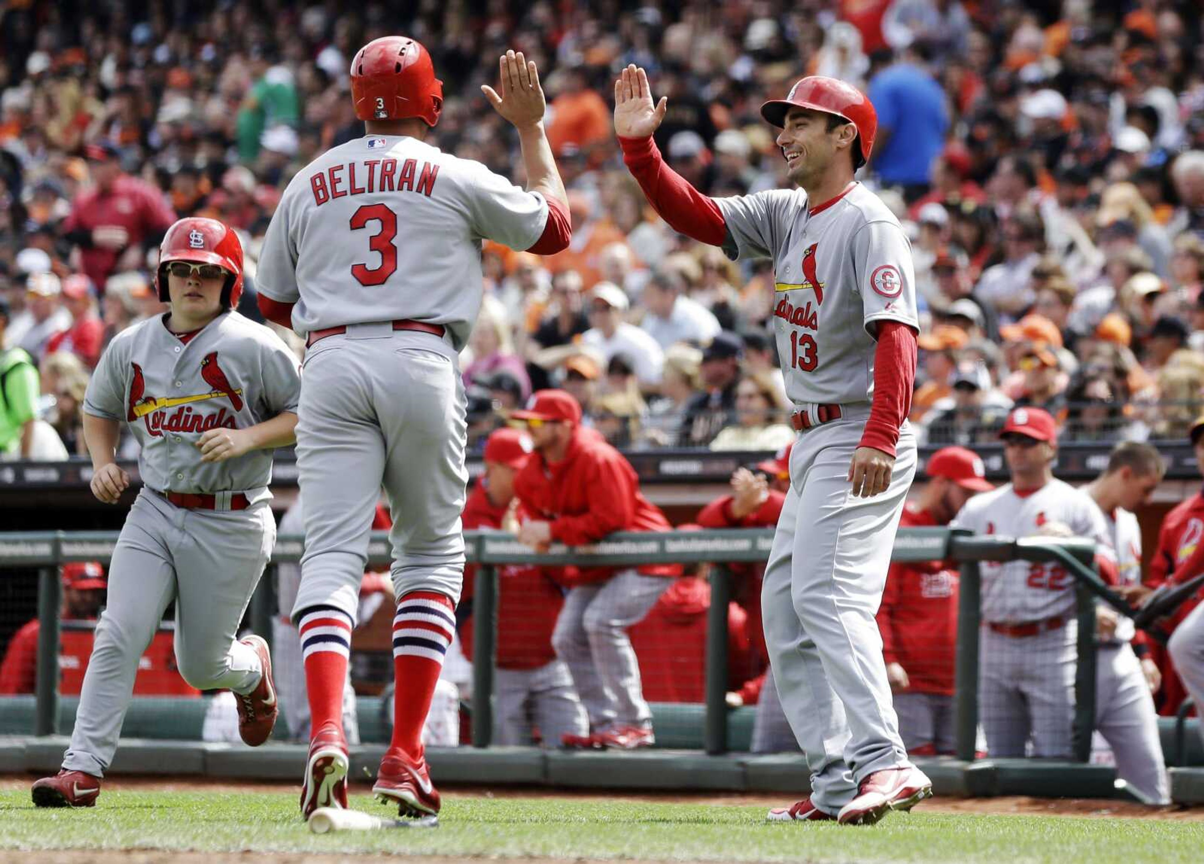 St. Louis Cardinals' Carlos Beltran, left, and Matt Carpenter celebrate after both scoring on a ground rule double from Matt Adams during the fourth inning of a baseball game against the San Francisco Giants, Sunday, April 7, 2013, in San Francisco. (AP Photo/Marcio Jose Sanchez)