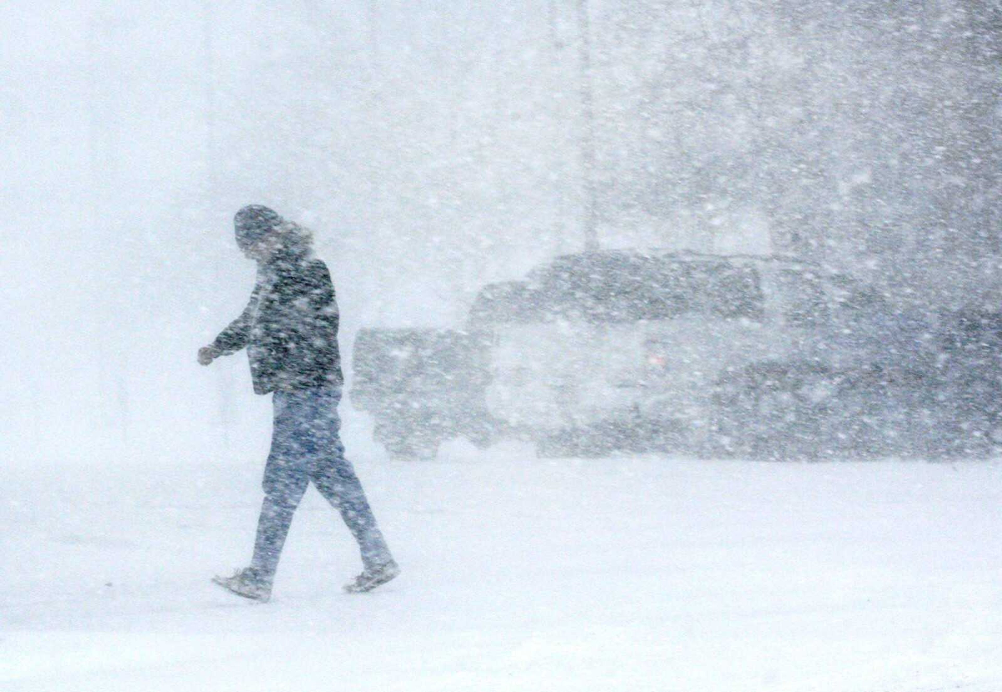 A man walked through the blowing snow Saturday in downtown Topeka, Kan. Visibility was limited by the heavy blowing snow, causing a pileup on Interstate 70 near Alma, Kan., and other accidents throughout the northeast part of the state. (ANTHONY S. BUSH ~ Topeka Capital-Journal)