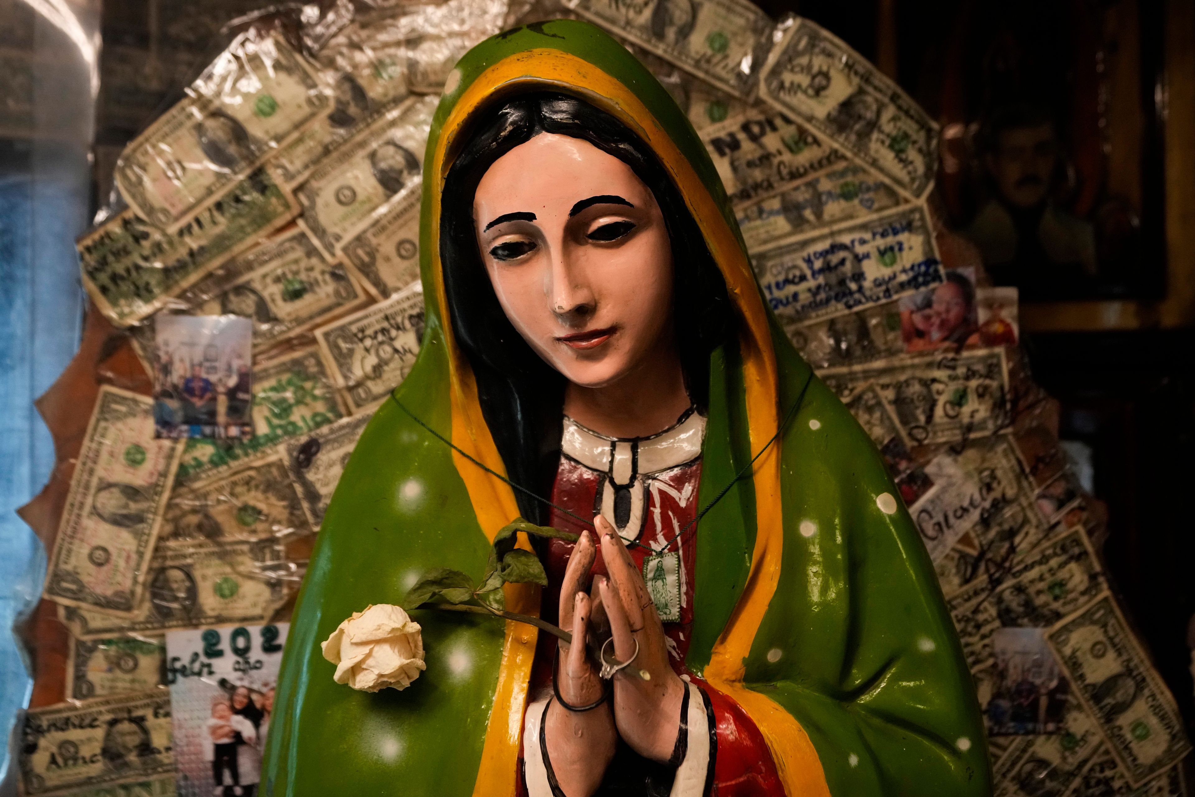 A statue of the Virgin of Guadalupe is displayed inside a shrine dedicated to Jesus Malverde, a folk saint viewed as the patron or protector of people involved in the drug trade, in Culiacan, Sinaloa state, Mexico, Friday, Sept. 20, 2024. (AP Photo/Eduardo Verdugo)