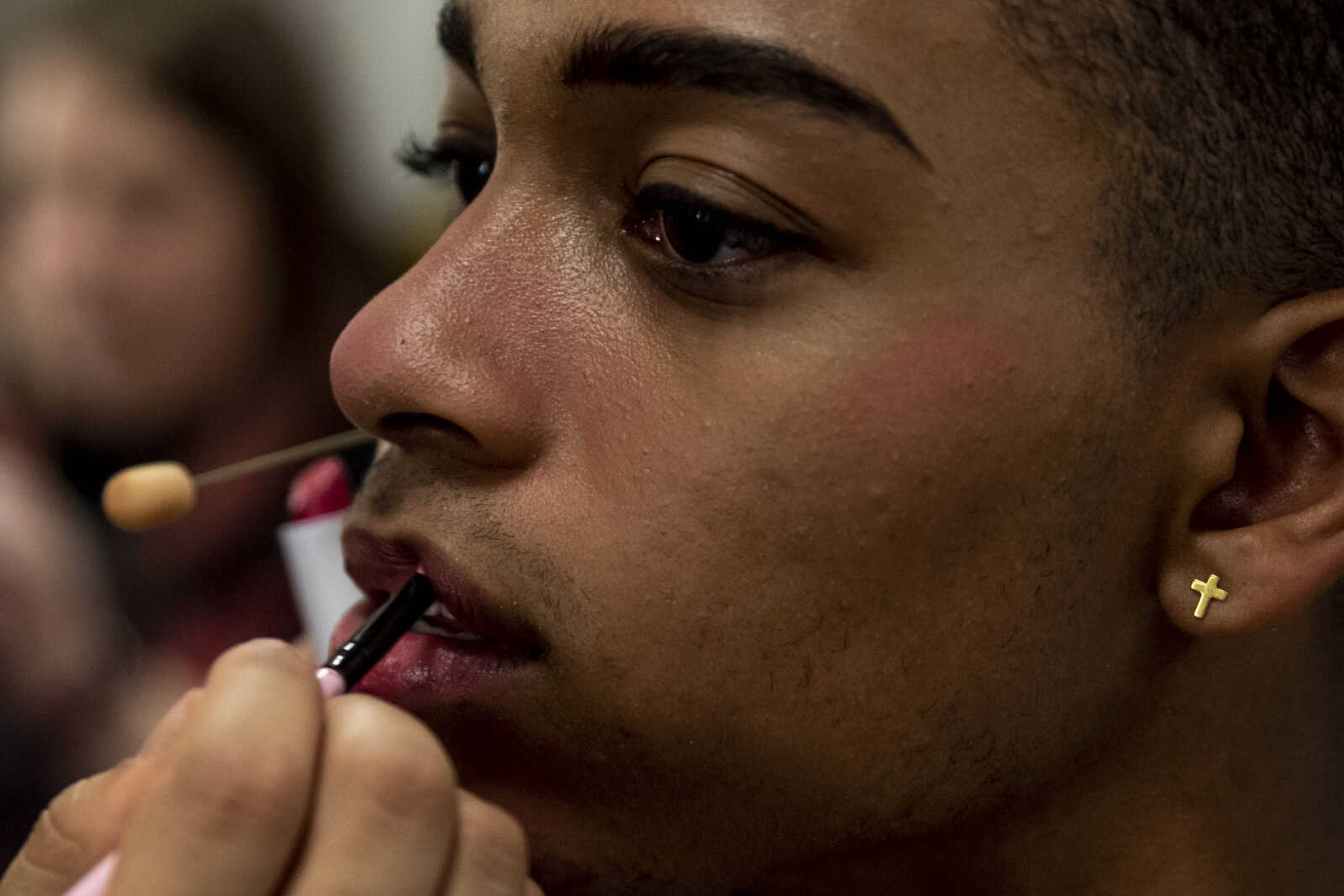 Izahia Betancur, 16, sits while Po Nwe applies makeup to transform him into the character of Sky for Cape Central High School's spring musical production of "Mamma Mia!" Wednesday, April 10, 2019, in Cape Girardeau.