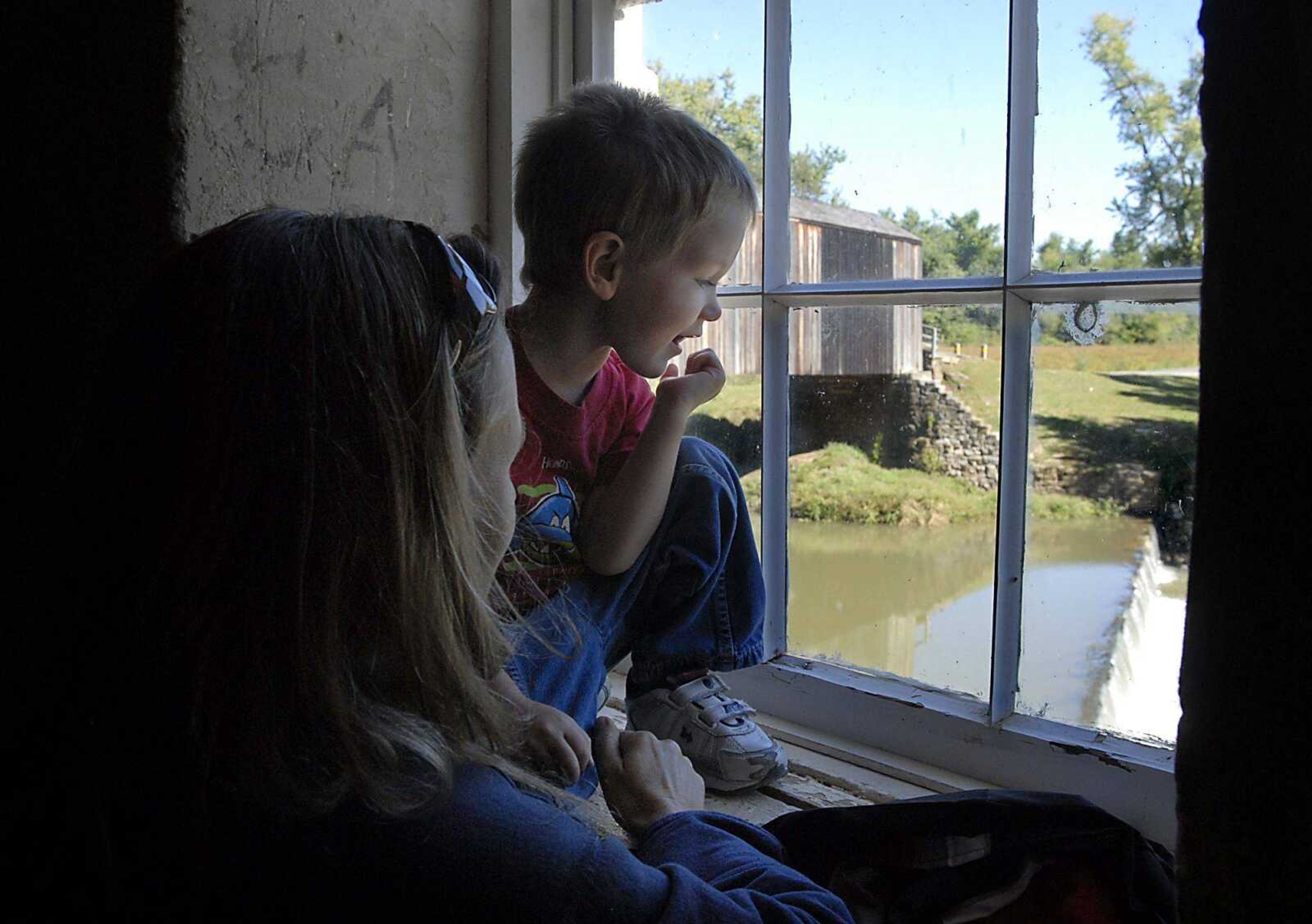 Betsy Kunz shows her son Jeremiah, 3, the view from Bollinger Mill State Historic Site to the Whitewater River below Wednesday morning in Burfordville. Attendance to state parks is down dramatically over the past decade. (Kit Doyle)