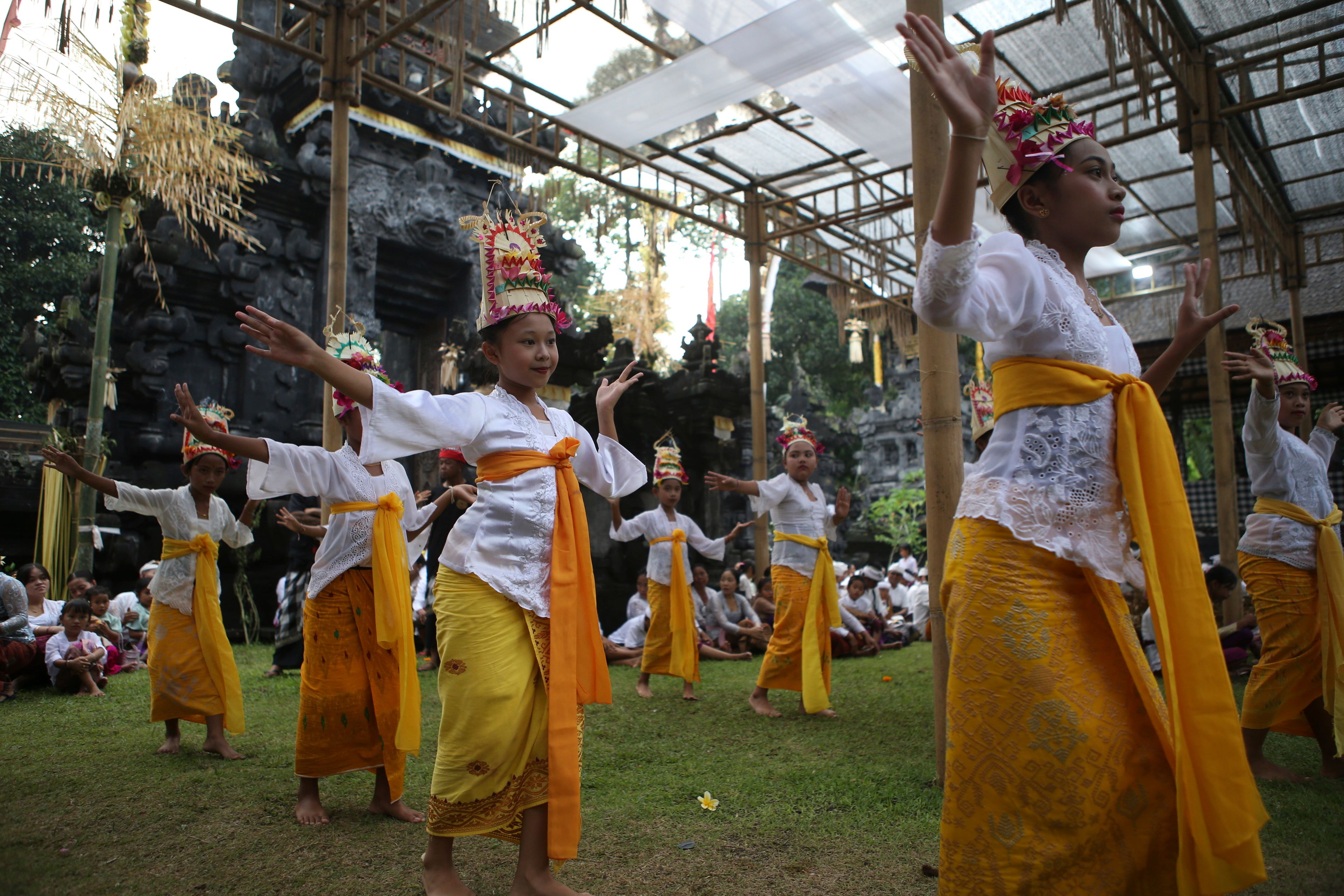 Ketut Nita Wahyuni, 11, centre, performs the Rehang Dewa, a sacred Balinese dance, at Geriana Kauh village, Karangasem, Bali, Indonesia on Wednesday, Nov. 20, 2024. (AP Photo/Firdia Lisnawati)