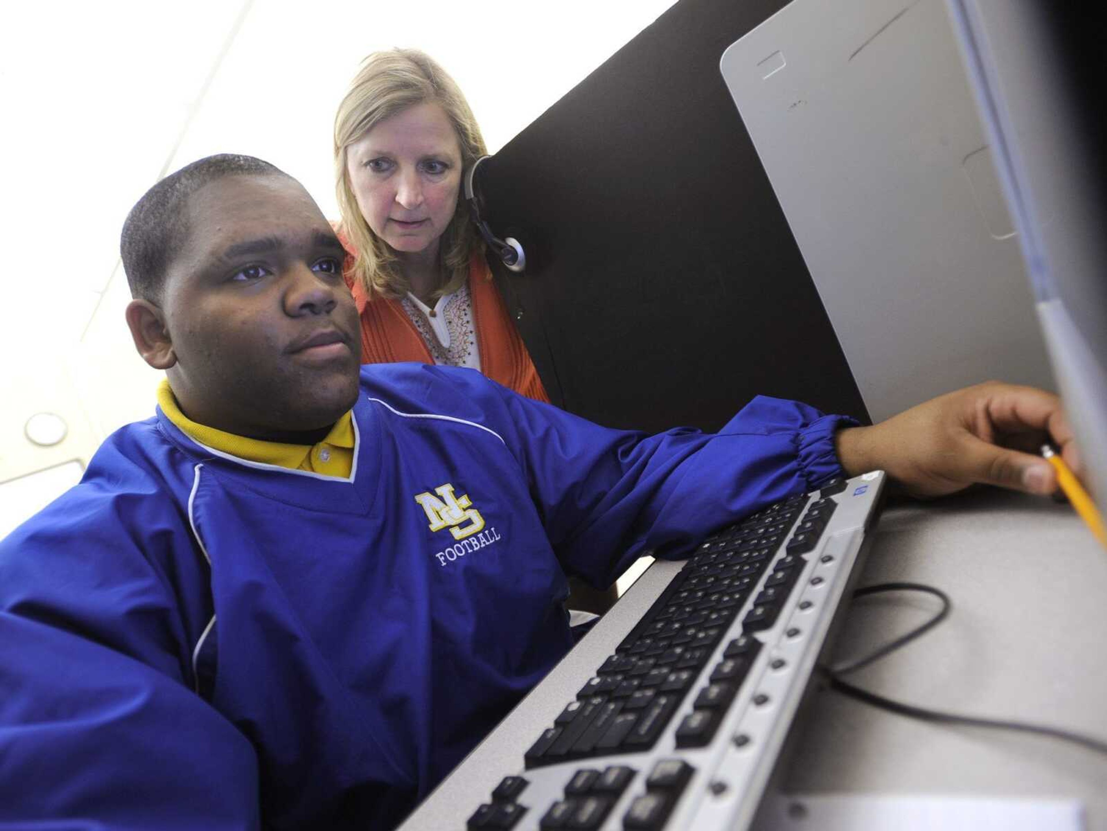 Darieth Nunley, a senior at Central High School, works on a consumer education lesson Thursday with Barb Randolph, a tutor with the credit recovery program, at the Cape Alternative Education Center. (Fred Lynch)