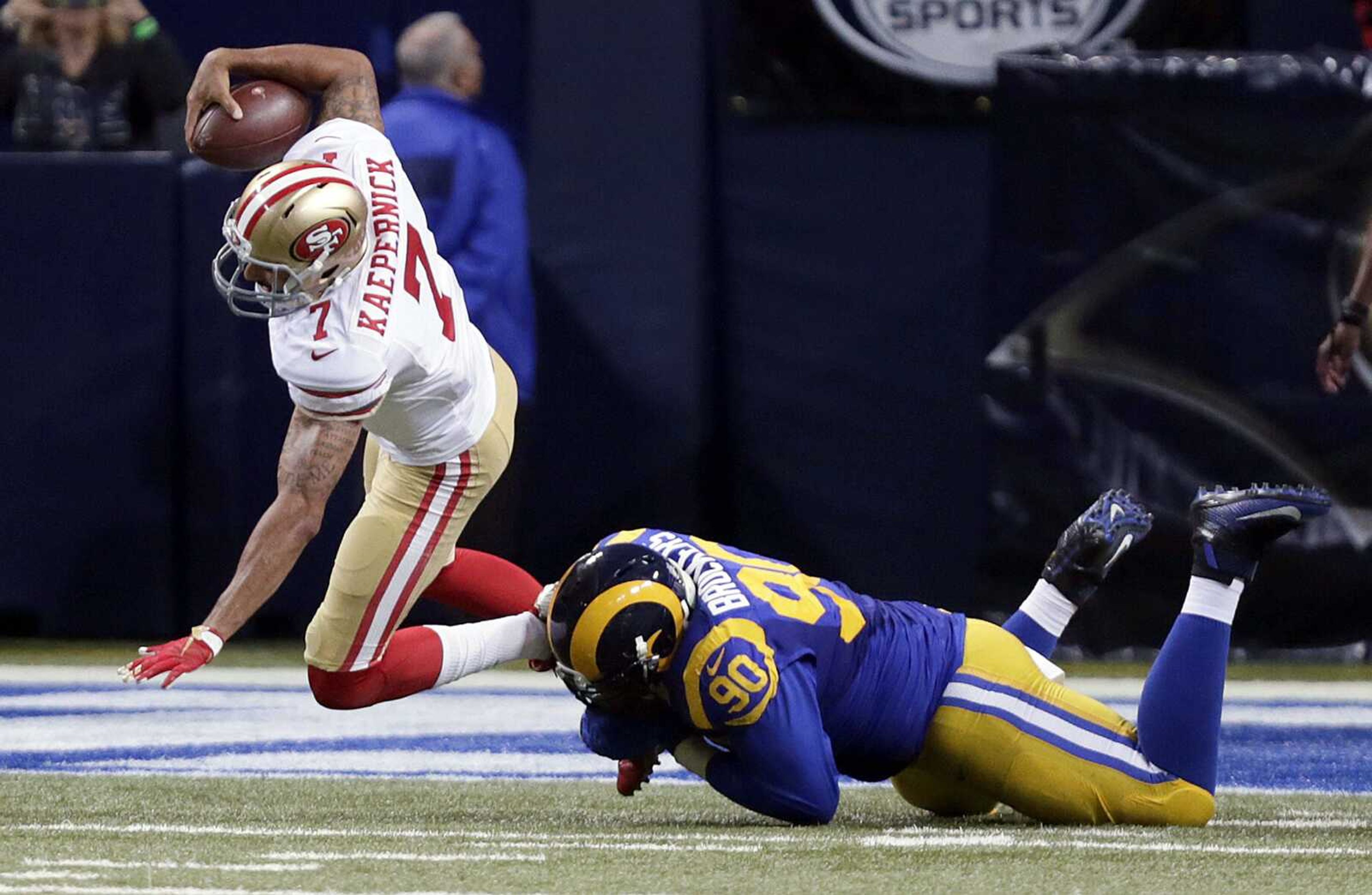 49ers quarterback Colin Kaepernick is sacked for a 3-yard loss by Rams defensive tackle Michael Brockers during the second quarter Sunday in St. Louis. (Tom Gannam ~ Associated Press)