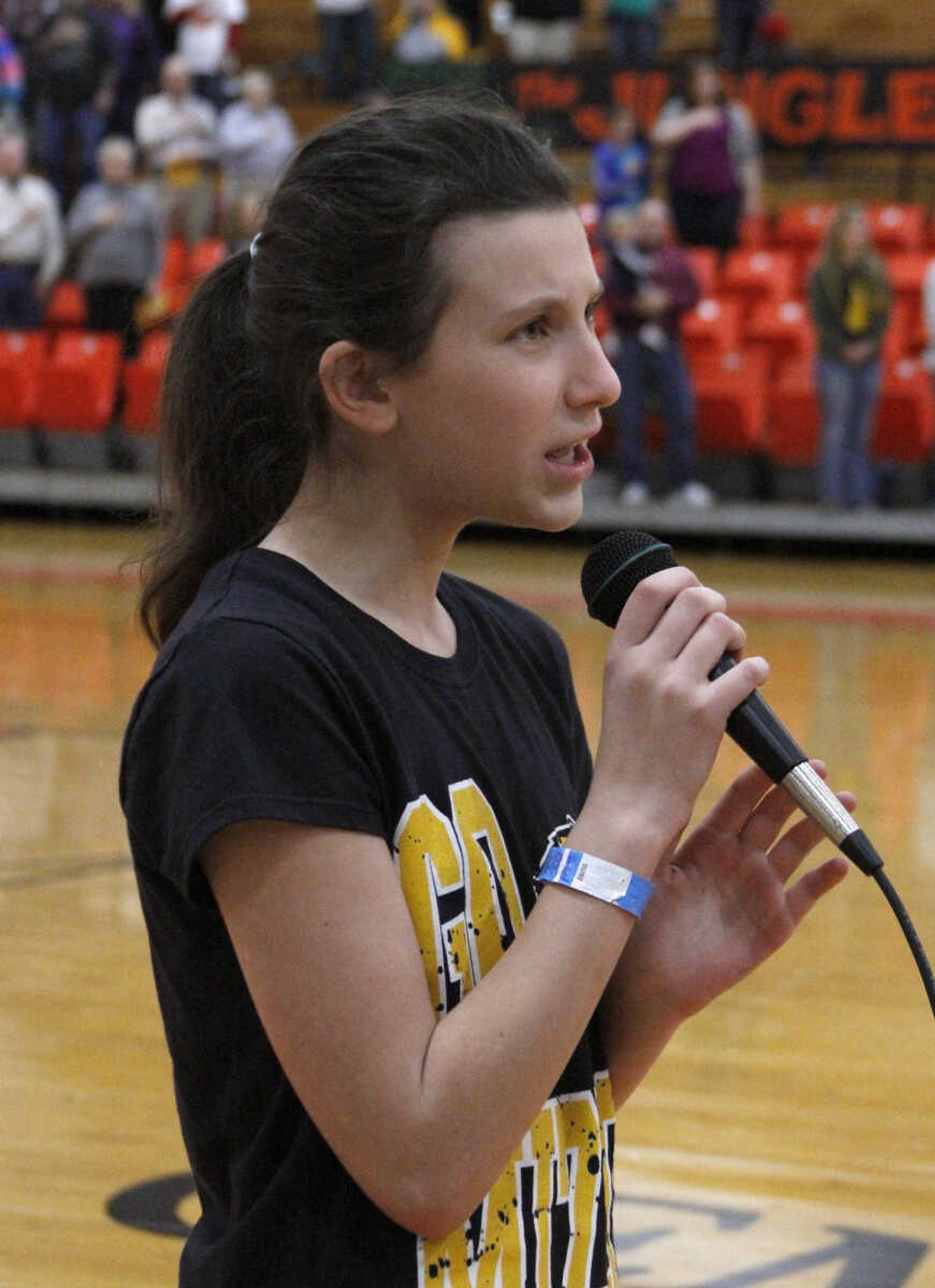 JONATHAN BRIDGES ~ photos@semissourian.com
Reagan Perniciaro sings the National Anthem Saturday, March 3, 3012 before the start of the19th annual Doctors vs. Lawyers basketball showdown at Cape Central Junior High School in Cape Girardeau. Doctors won 84-70.