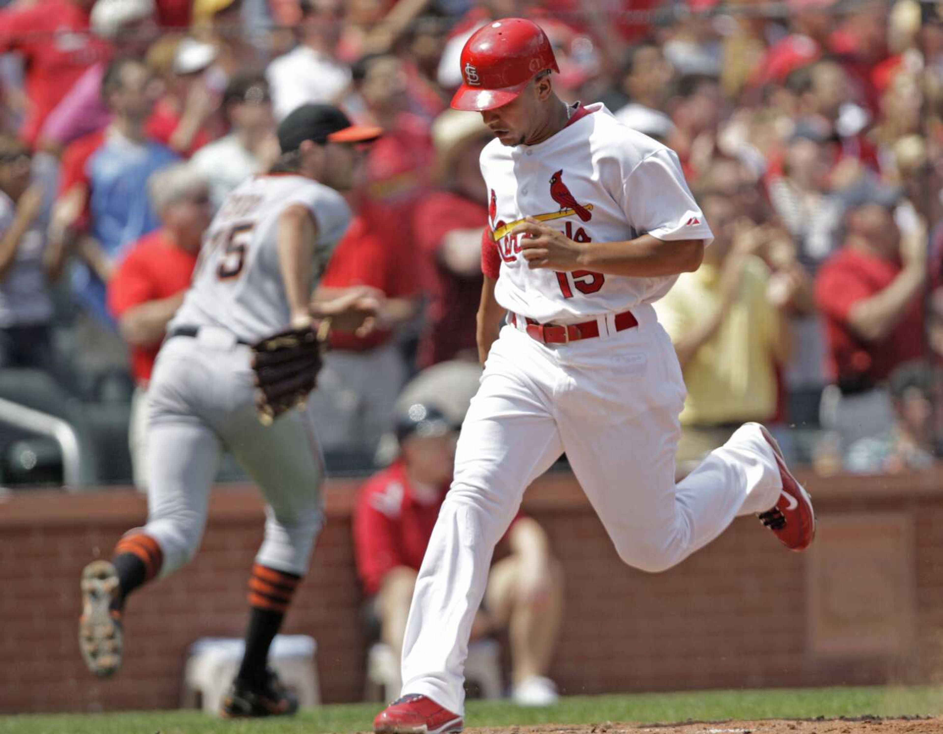 St. Louis Cardinals' Jon Jay (15) scores from second on a single by Matt Holiday as San Francisco Giants starting pitcher Barry Zito (75) runs to cover the throw home in the third inning of a baseball game, Sunday, Aug. 22, 2010, in St. Louis.(AP Photo/Tom Gannam)