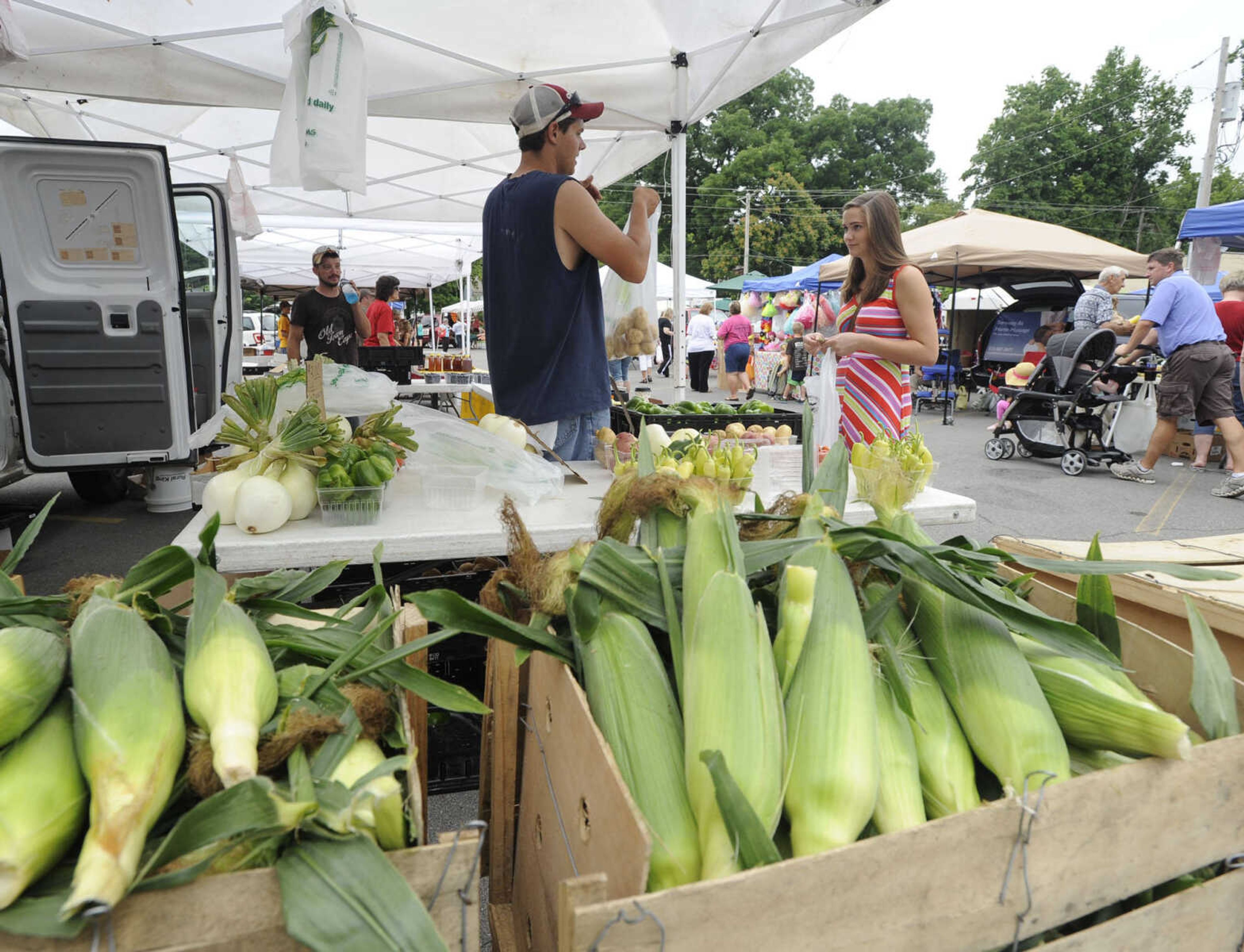 FRED LYNCH ~ flynch@semissourian.com
Reagan Brown of McClure, Ill. shops at a booth operated by Austin Pender with Bass Farms of Cobden, Ill. Saturday, July 6, 2013 at the Cape Riverfront Market in Cape Girardeau.