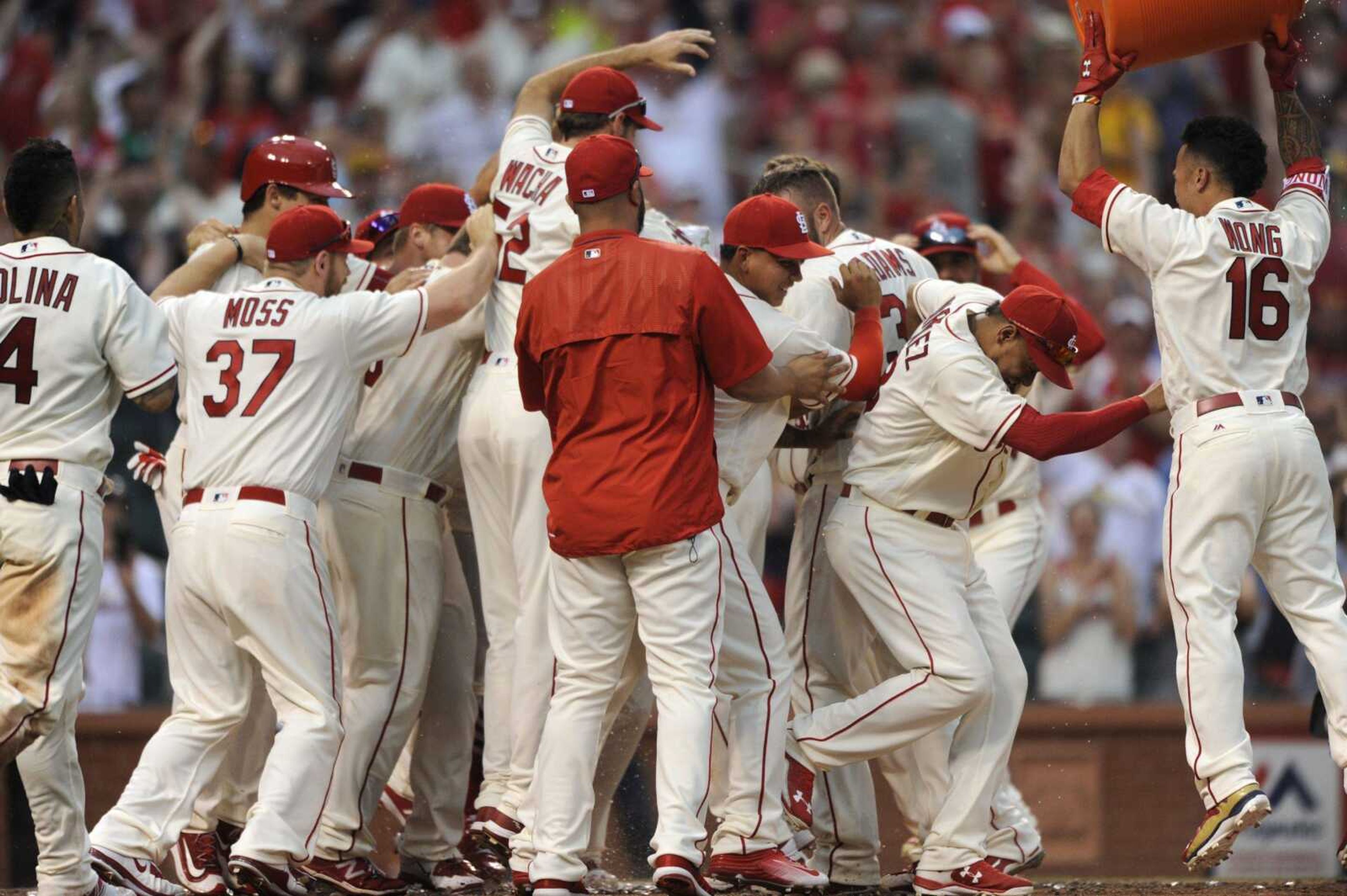 Cardinals players celebrate a two-run, walk-off home run by Matt Carpenter in the ninth inning against the Pirates on Saturday in St. Louis.