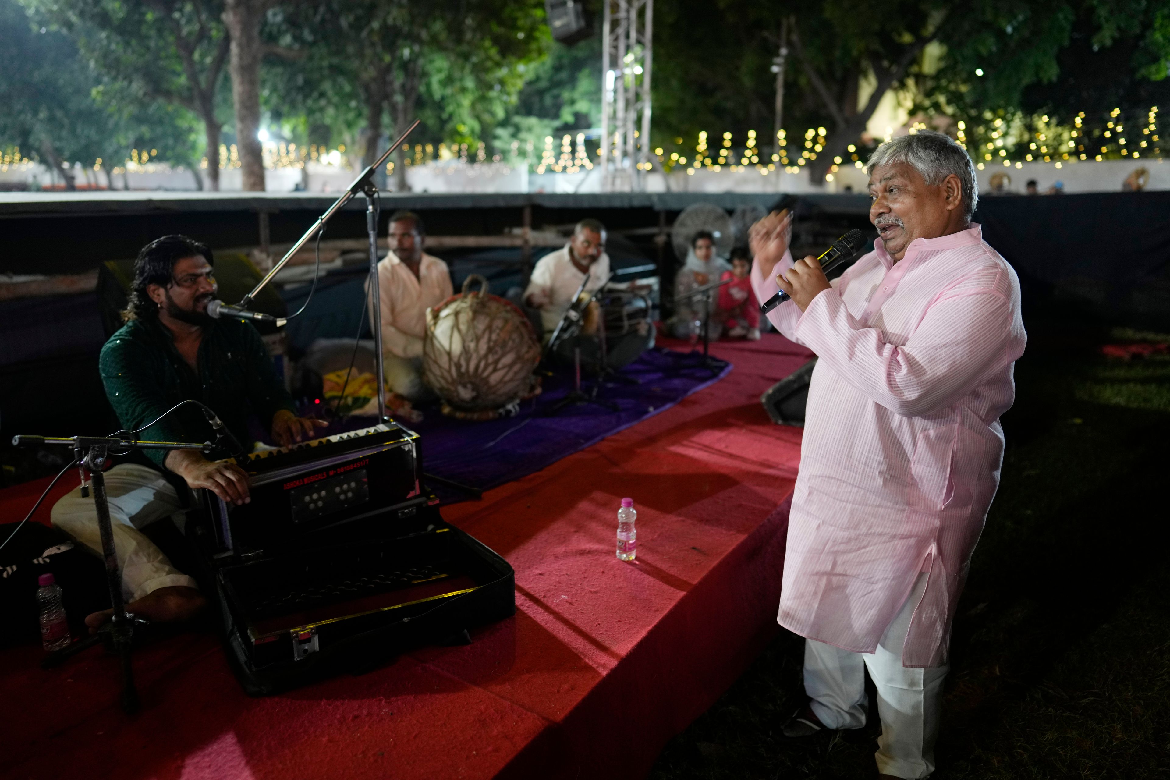 Theatre director Rakesh Ratnakar, 65, sings from the music pit during Ramleela, a dramatic folk re-enactment of the life of Hindu god Rama according to the ancient Hindu epic Ramayana, in New Delhi, India, Wednesday, Oct. 9, 2024. (AP Photo/Manish Swarup)