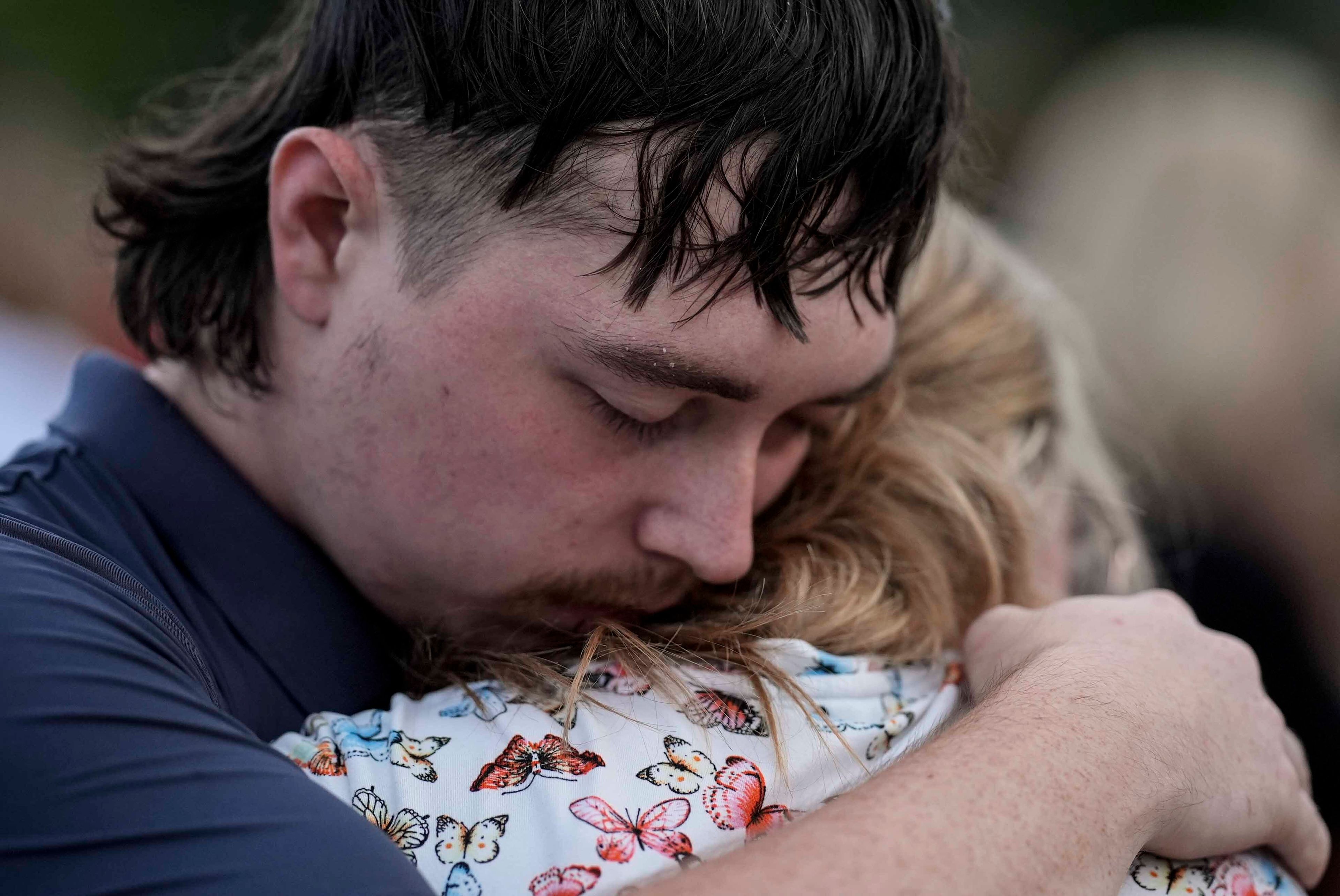 Mourners pray during a candlelight vigil for the slain students and teachers at Apalachee High School, Wednesday, Sept. 4, 2024, in Winder, Ga. (AP Photo/Mike Stewart)