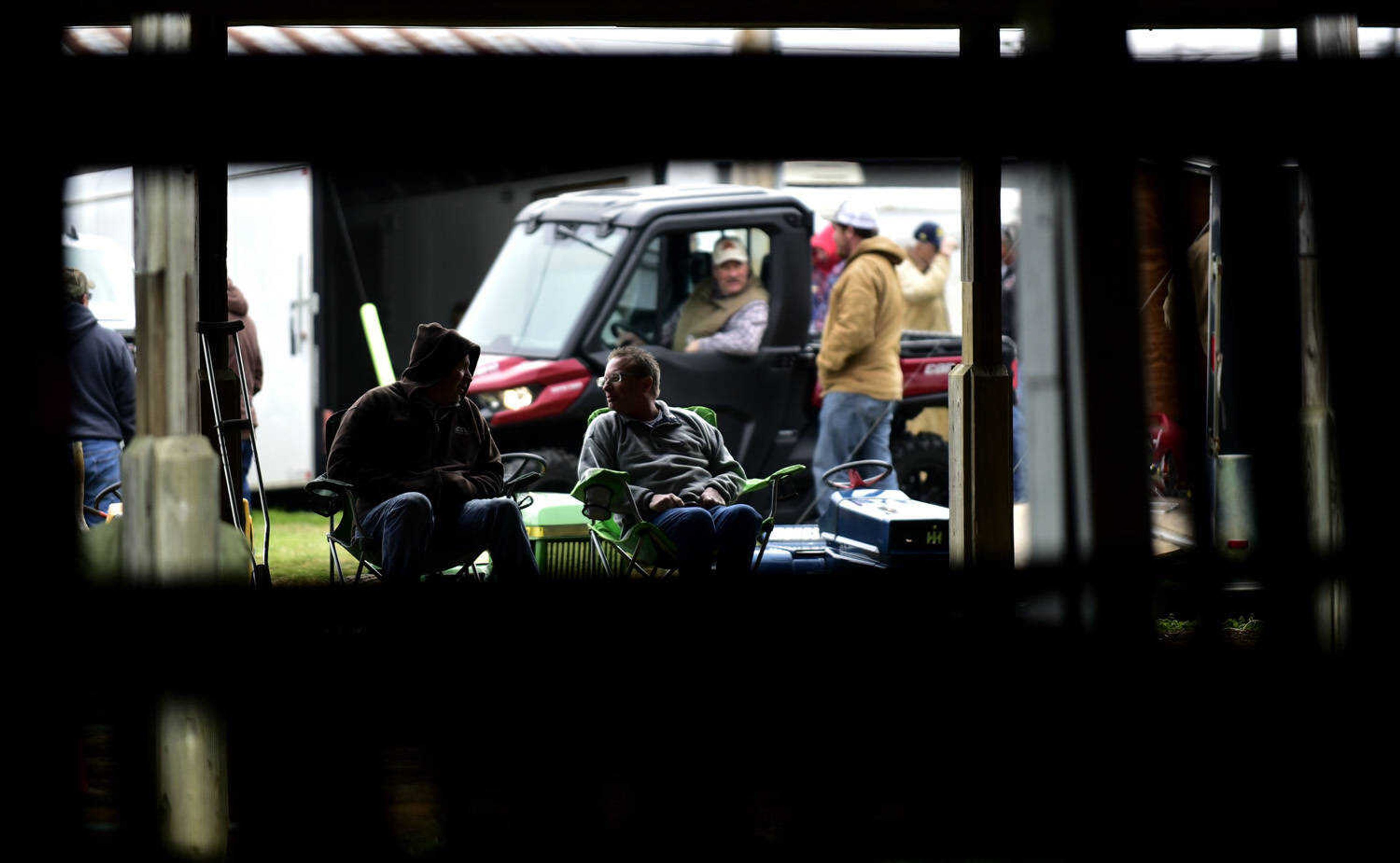 Participants in the garden tractor pull engage in conversation at the Cousin Carl Farm Show on Saturday, March 10, 2018, at Arena Park in Cape Girardeau.