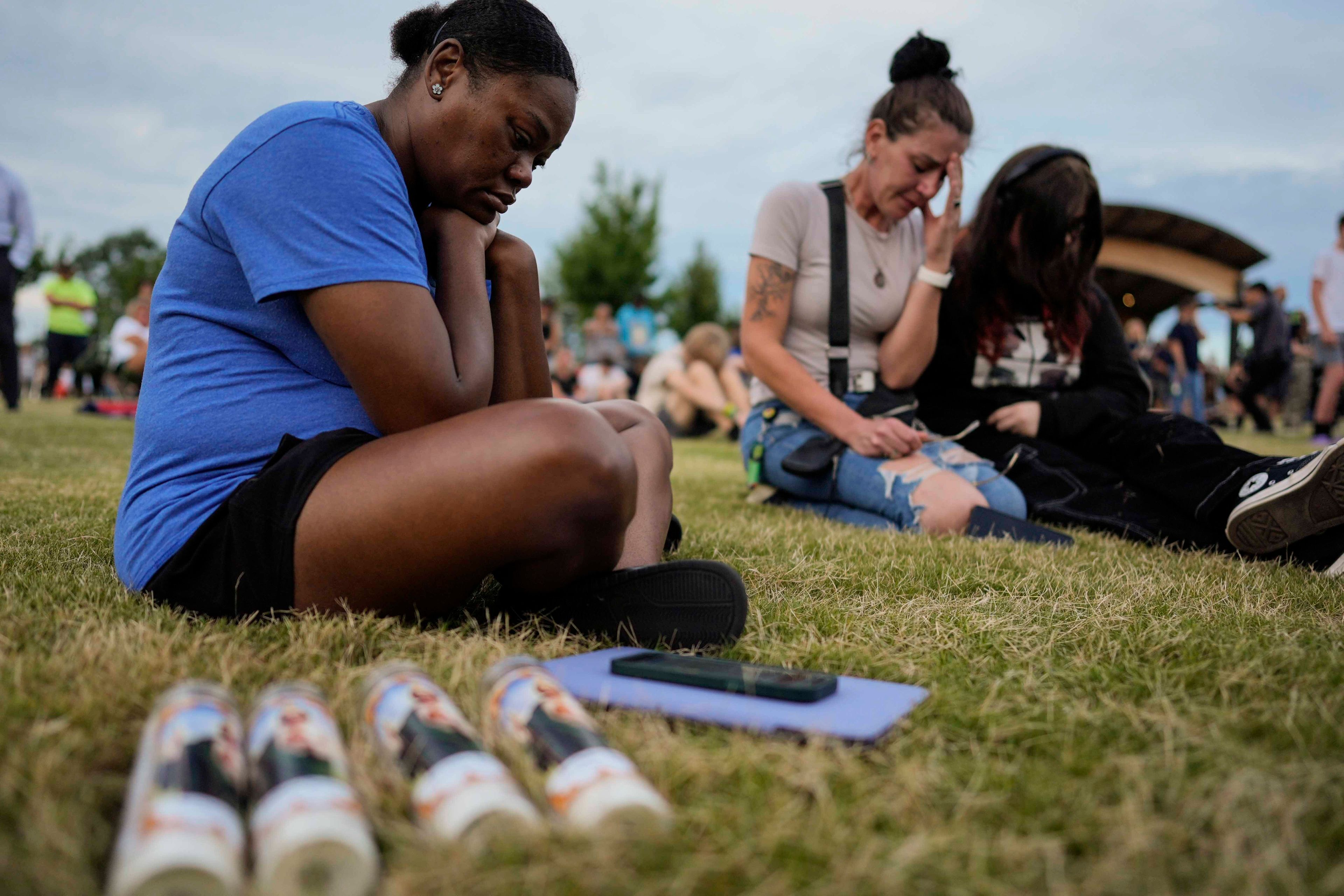 Mourners pray during a candlelight vigil for the slain students and teachers at Apalachee High School, Wednesday, Sept. 4, 2024, in Winder, Ga. (AP Photo/Mike Stewart)