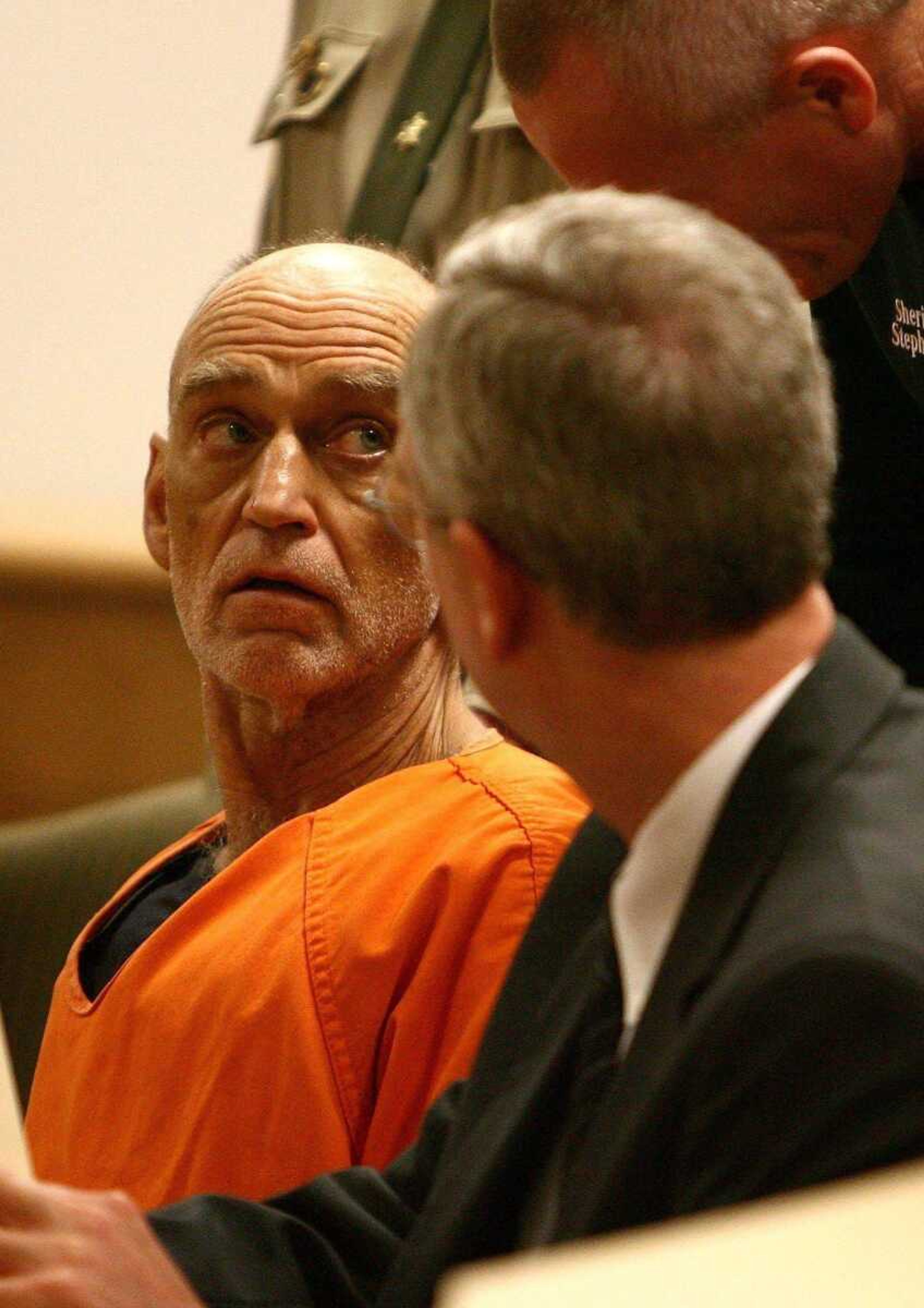 Gary Michael Hilton, left, glanced up while talking to to his public defender, Neil Smith, right, following a first appearance in Union County Magistrate Court in Blairsville, Ga., on Monday. (BEN GRAY ~ Associated Press)