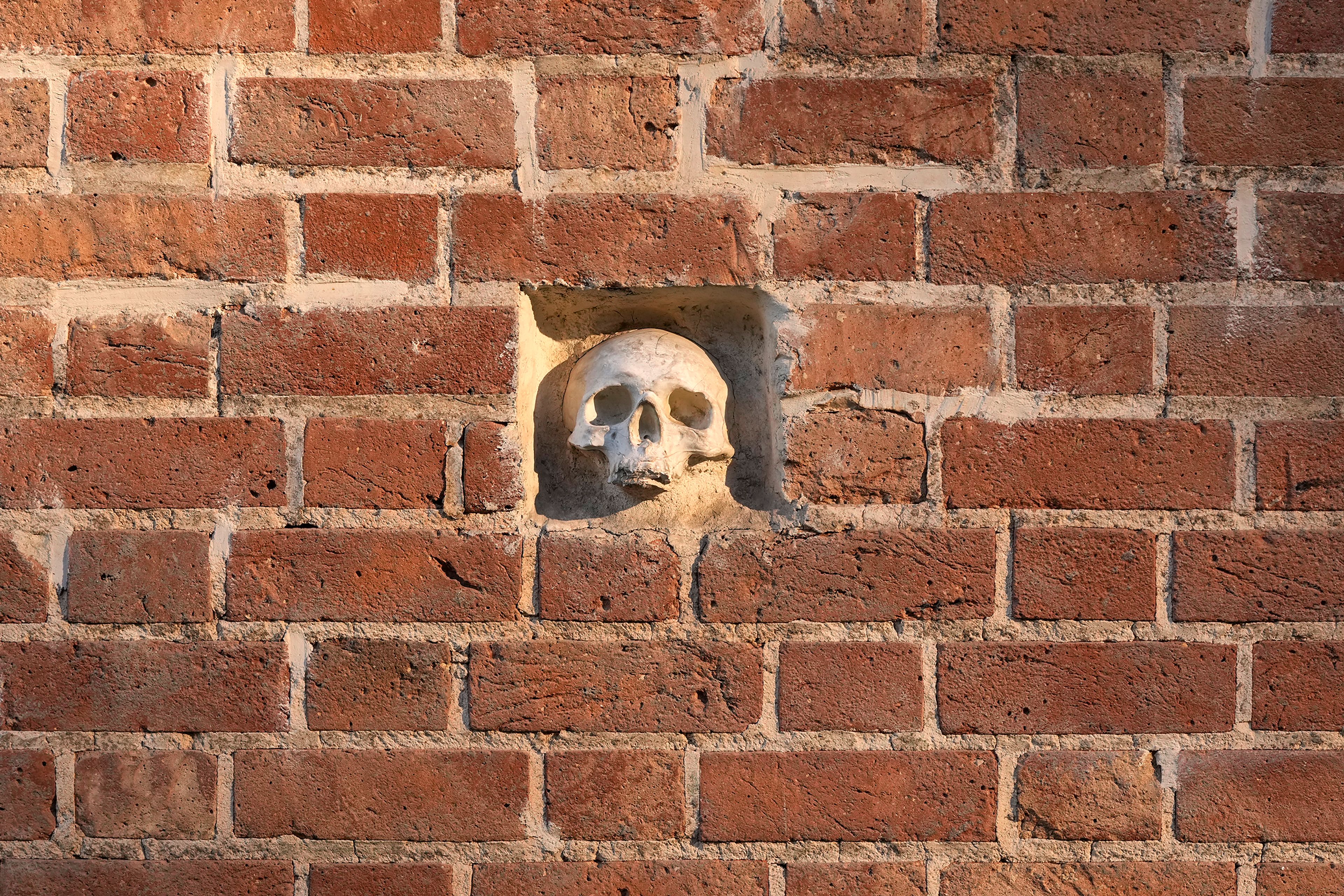 An artificial skull is placed into the exterior wall of the former U.S. Embassy, which has been turned into an anti-American museum, in Tehran, Iran, Tuesday, Oct. 22, 2024. (AP Photo/Vahid Salemi)