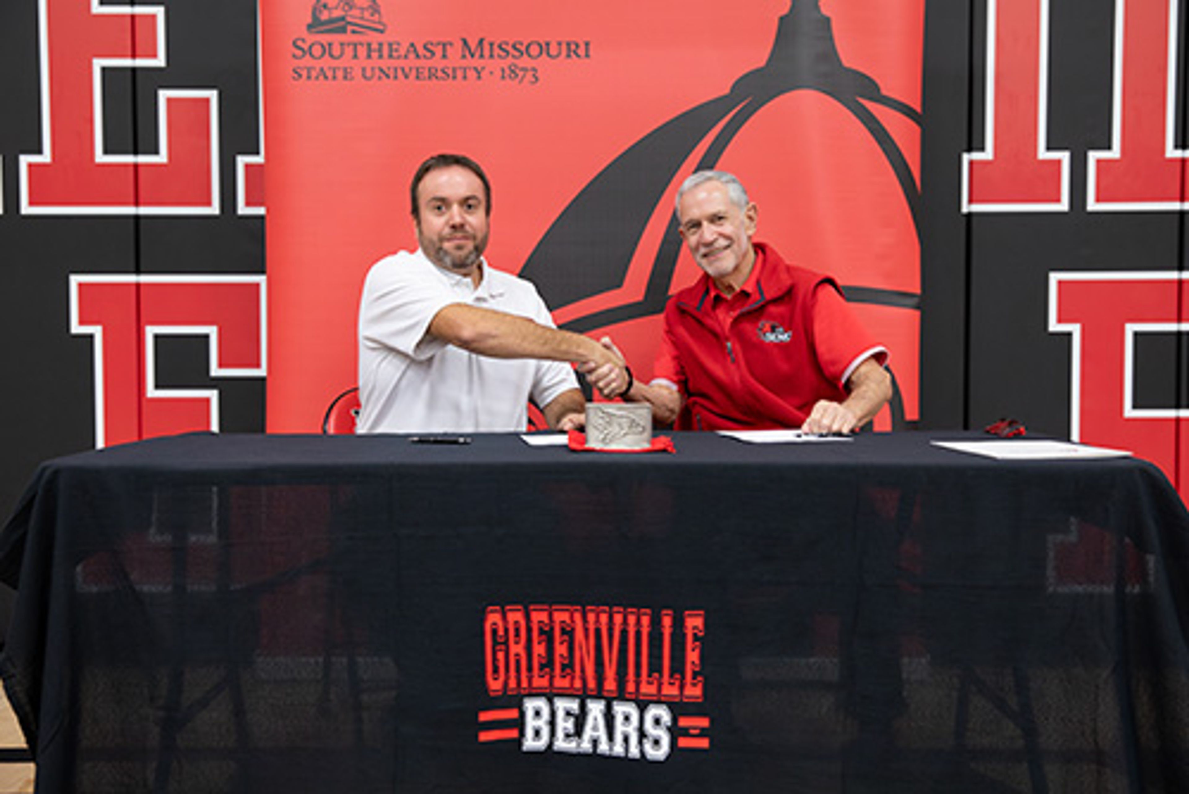 Greenville R-II Public Schools superintendent Rick Clubb, left, shakes hands with Southeast Missouri State University president Carlos Vargas after signing a partnership agreement to join SEMO’s Educators Advantage program.