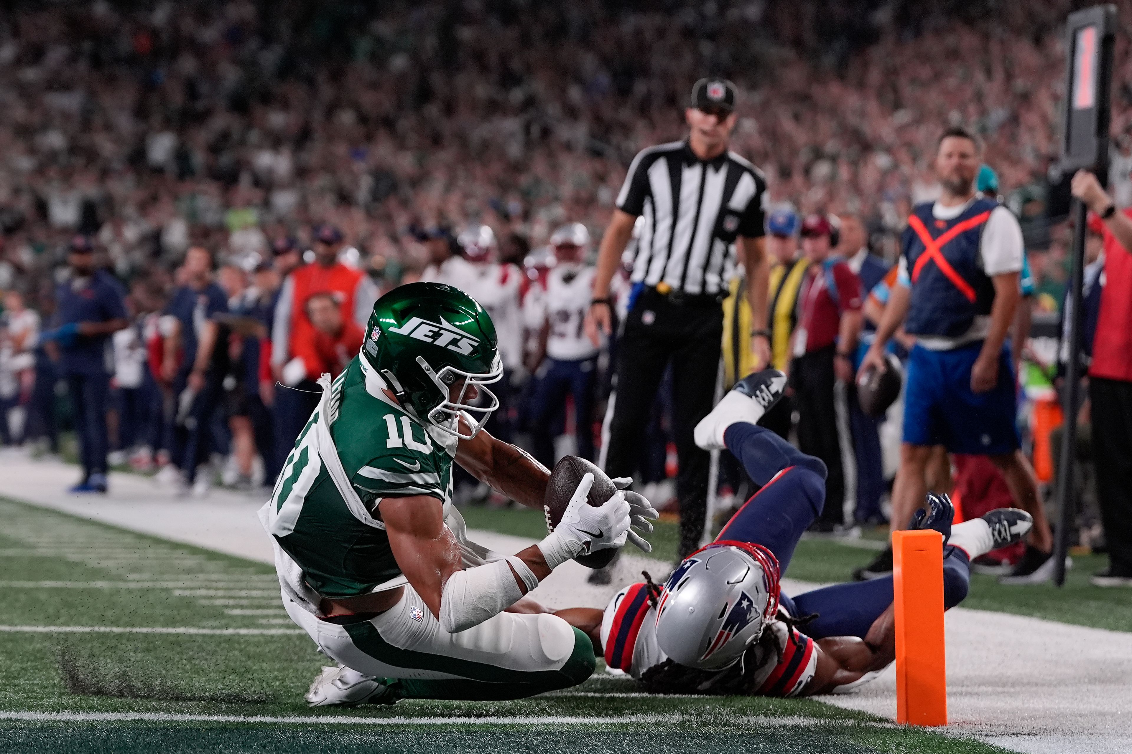 New York Jets wide receiver Allen Lazard (10) scores a touchdown against New England Patriots safety Kyle Dugger (23) during the first quarter of an NFL football game, Thursday, Sept. 19, 2024, in East Rutherford, N.J. (AP Photo/Julia Demaree Nikhinson)