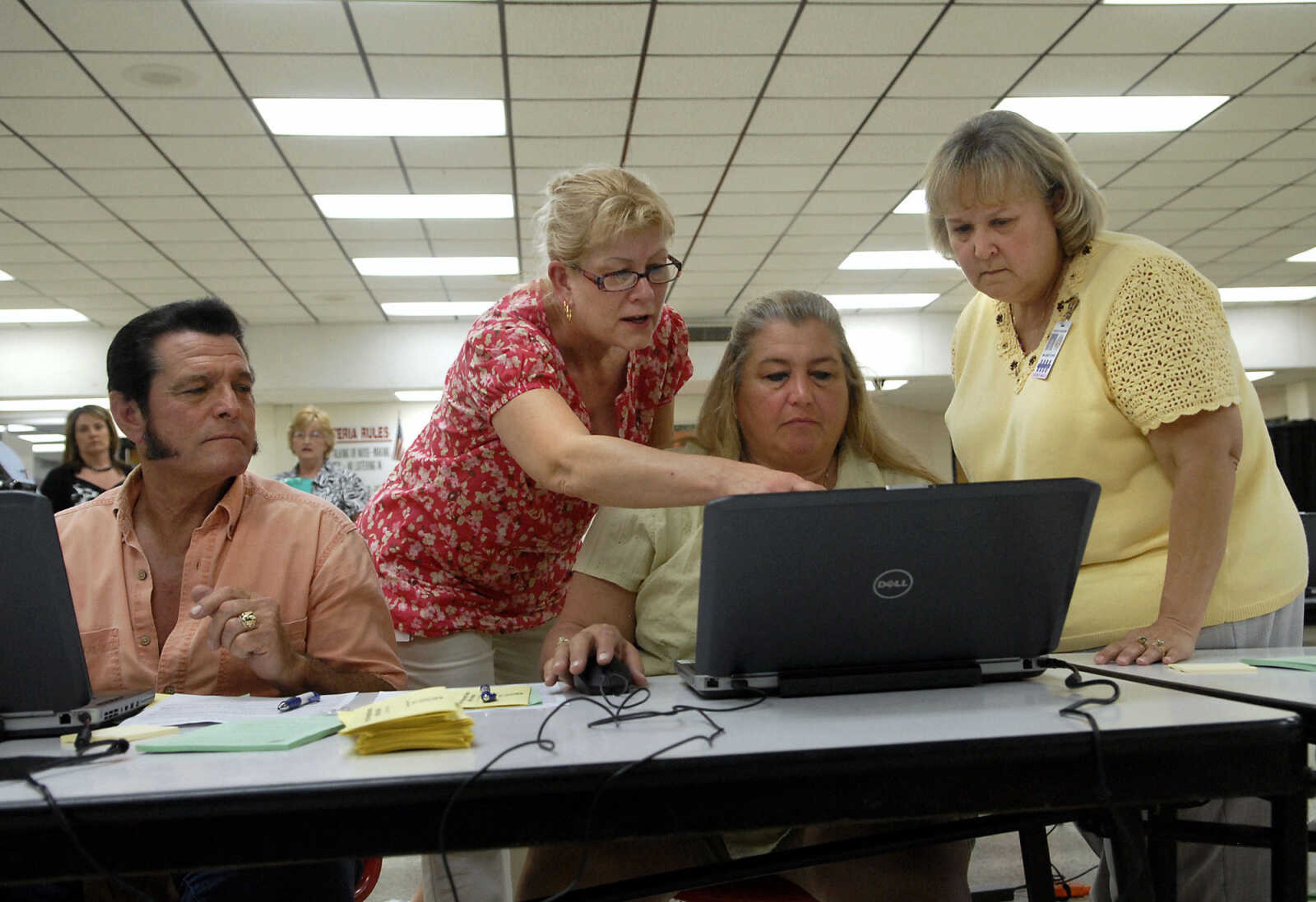 KRISTIN EBERTS ~ keberts@semissourian.com

David Bowman, left, and Nancy Bowman, second from right, work with Ruth Jaegers, second from left, and Cheryl Maloney, right, to file for unemployment assistance during a Community Response Meeting in Sikeston Mo., on Tuesday, May 10, 2011. The meeting aimed to assist flood victims by connecting them with state programs and agencies that can help them recover.