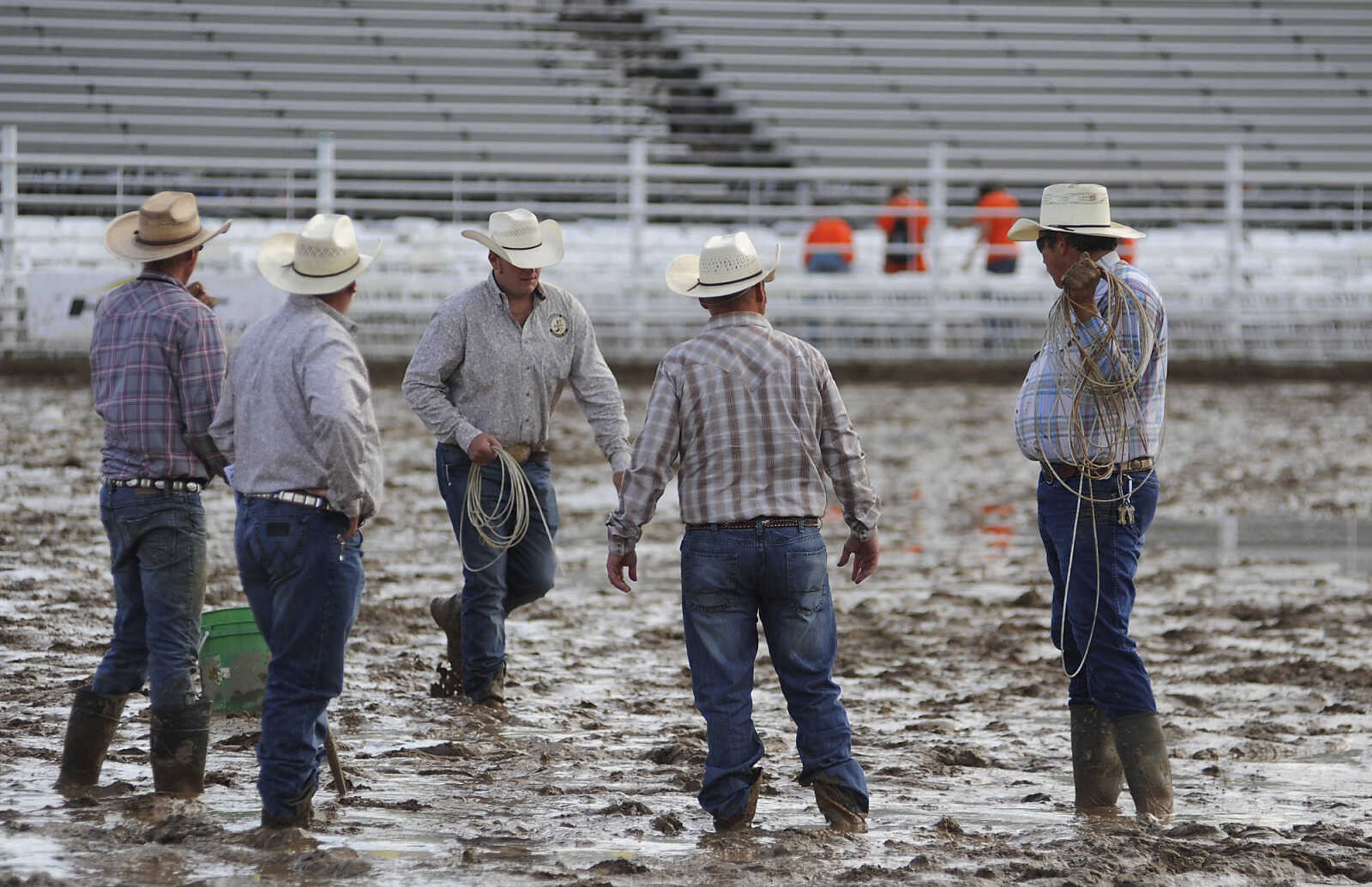 Workers prepare the arena before the Sikeston Jaycee Bootheel Rodeo Wednesday, August 7, in Sikeston, Mo.