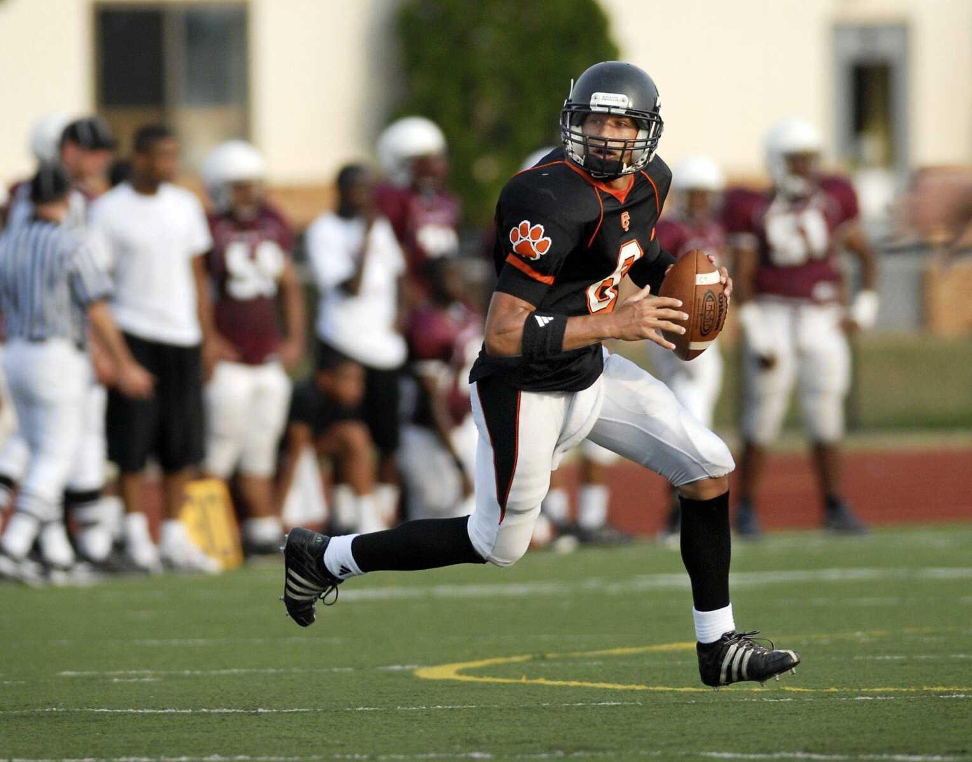 Central quarterback Christian Cavaness rolls out to pass during Friday's scrimmage against Poplar Bluff in Farmington, Mo.