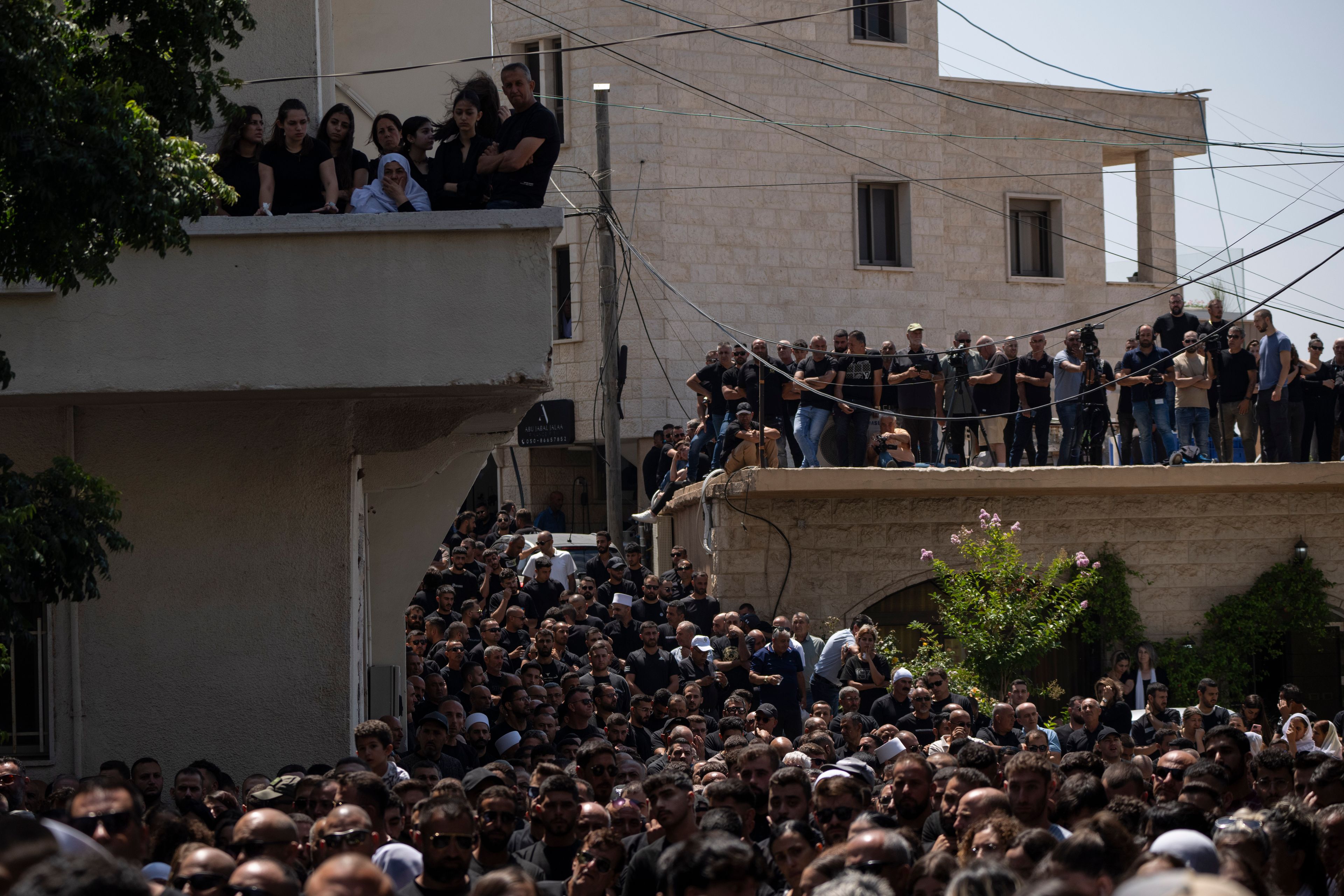 Mourners from the Druze minority attend the funeral of some of the 12 children and teens killed in a rocket strike at a soccer field at the village of Majdal Shams, in the Israeli-annexed Golan Heights, Sunday, July 28, 2024. It's the deadliest strike on an Israeli target along the country's northern border since the fighting between Israel and the Lebanese militant group Hezbollah began. (AP Photo/Leo Correa)