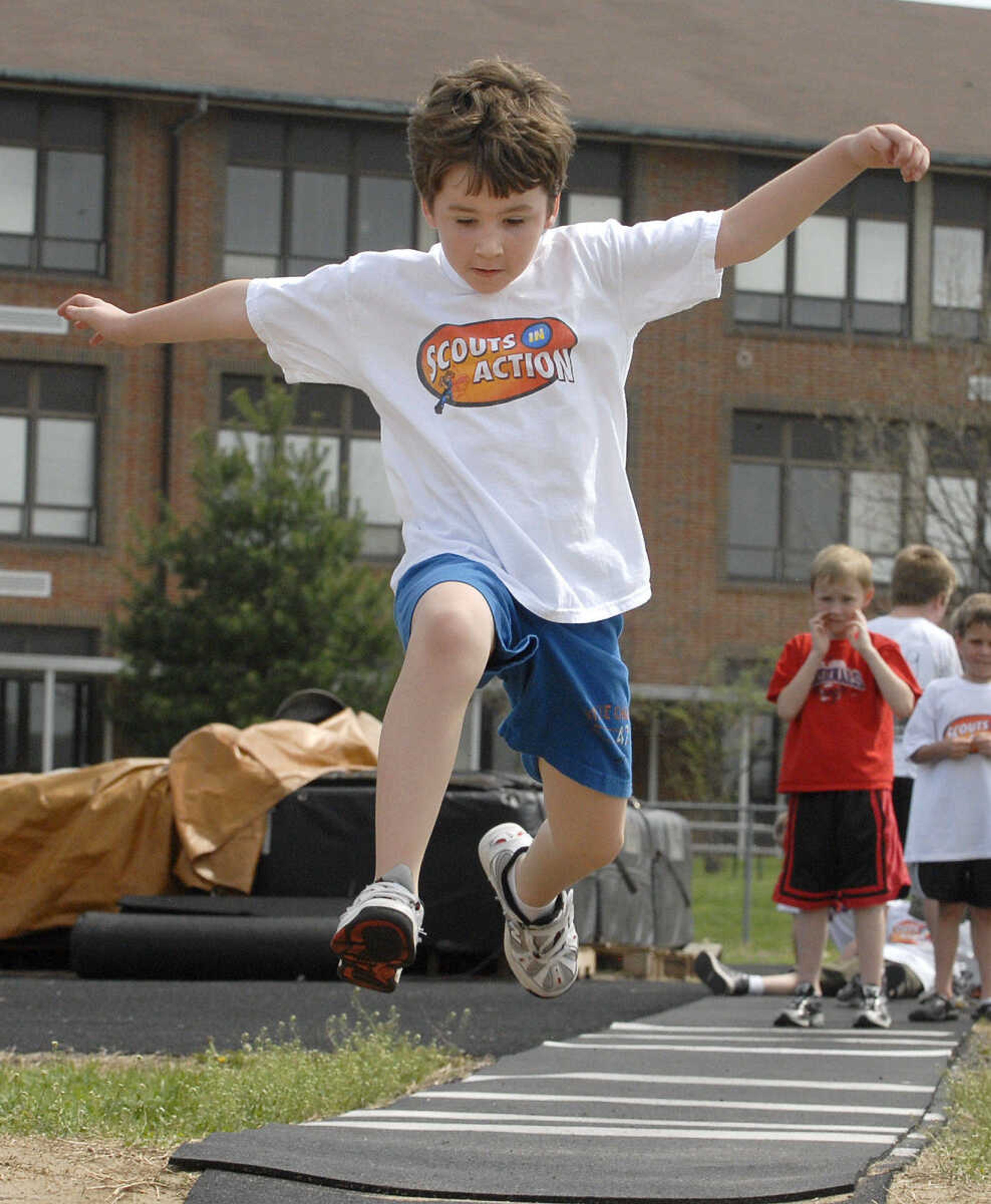 LAURA SIMON~lsimon@semissourian.com
Sean Riley sails through the air as he competes in the long jump Sunday, April 10, 2011 during the Cub Scout track and field day at Cape Central Junior High in Cape Girardeau.