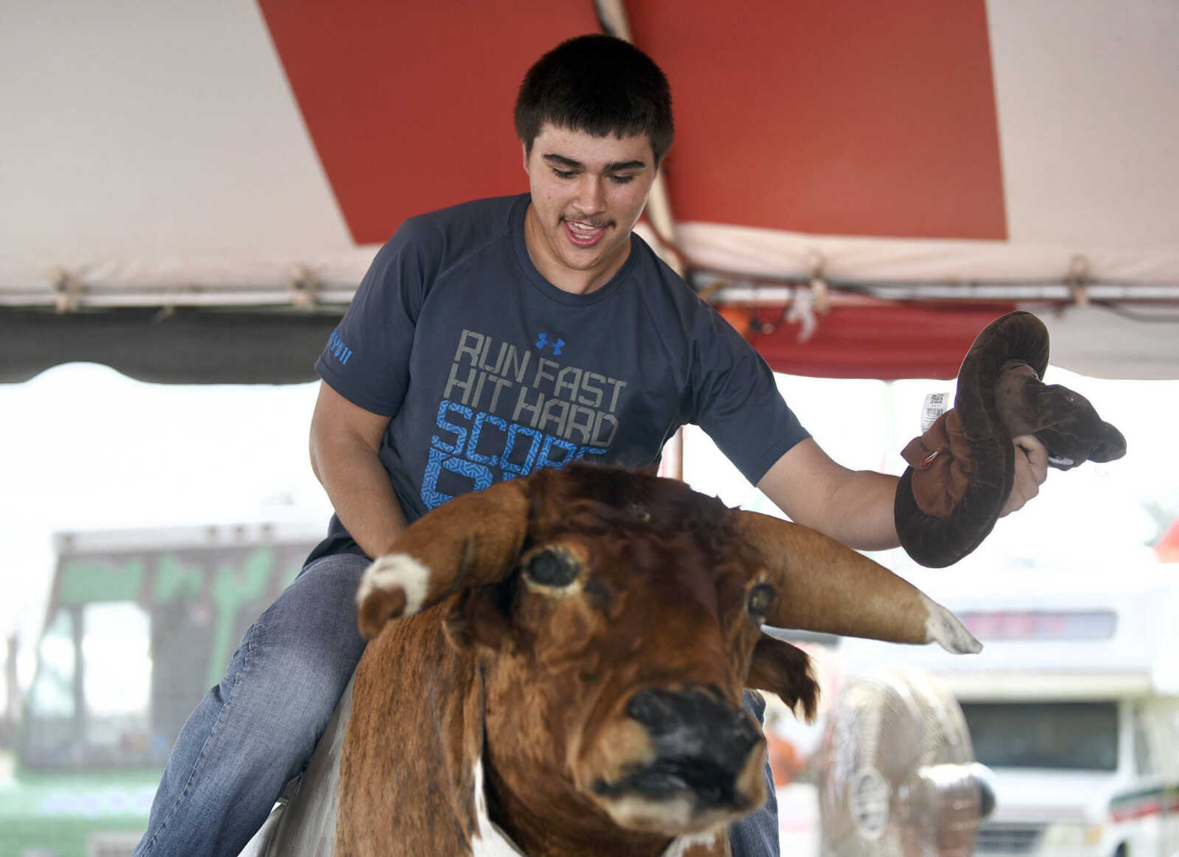 LAURA SIMON ~ lsimon@semissourian.com

People take a shot at the mechanical bull in the 8 Seconds Productions booth at the SEMO District Fair on Friday, Sept. 16, 2016, at Arena Park in Cape Girardeau.