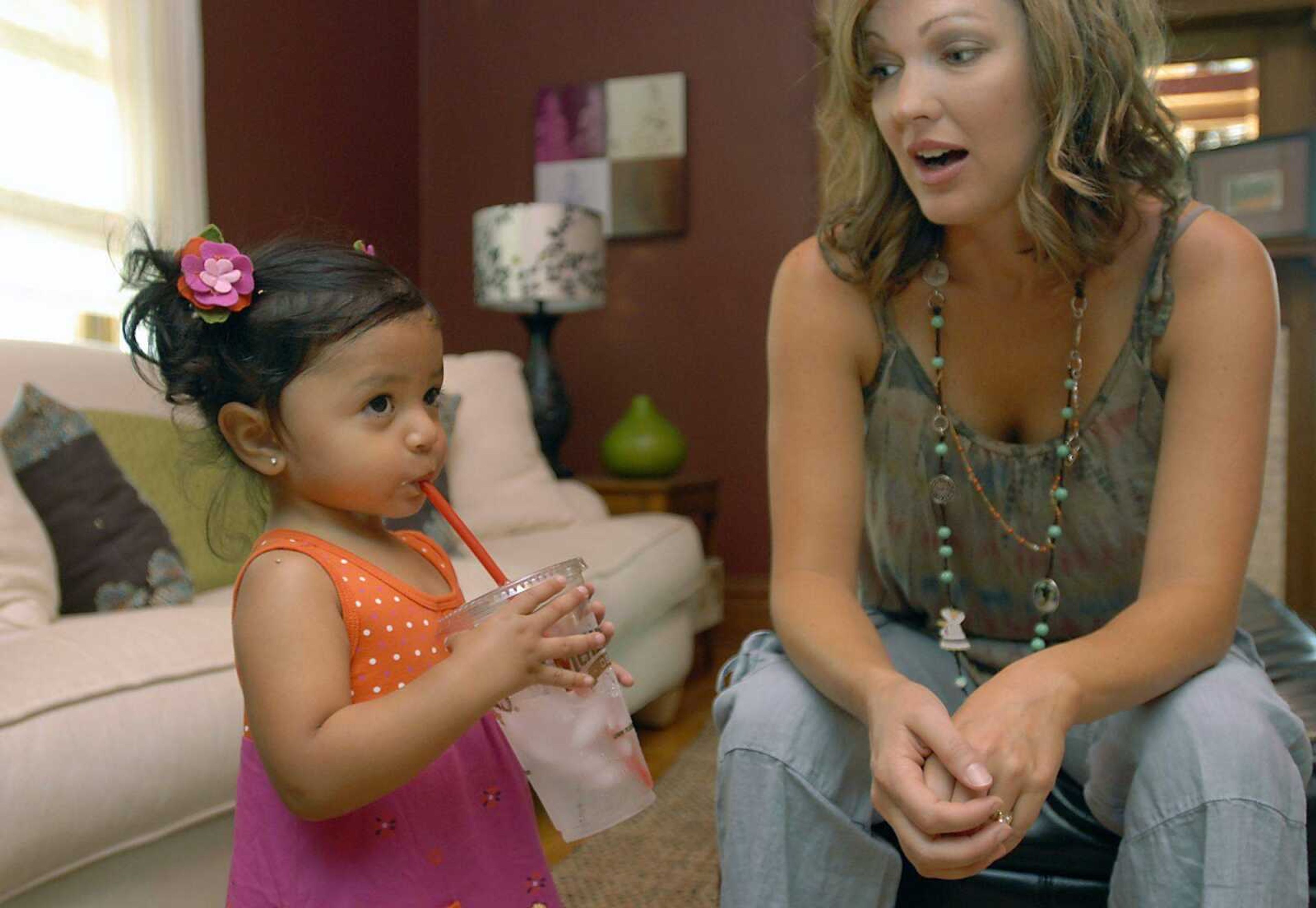 KIT DOYLE ~ kdoyle@semissourian.com
Chantelle Becking tells her daughter Bianca not to drink too much water Aug. 21 at their Cape Girardeau home. Bianca, almost 2, is teething and slobbers quite a bit after drinking too much water, Becking said.