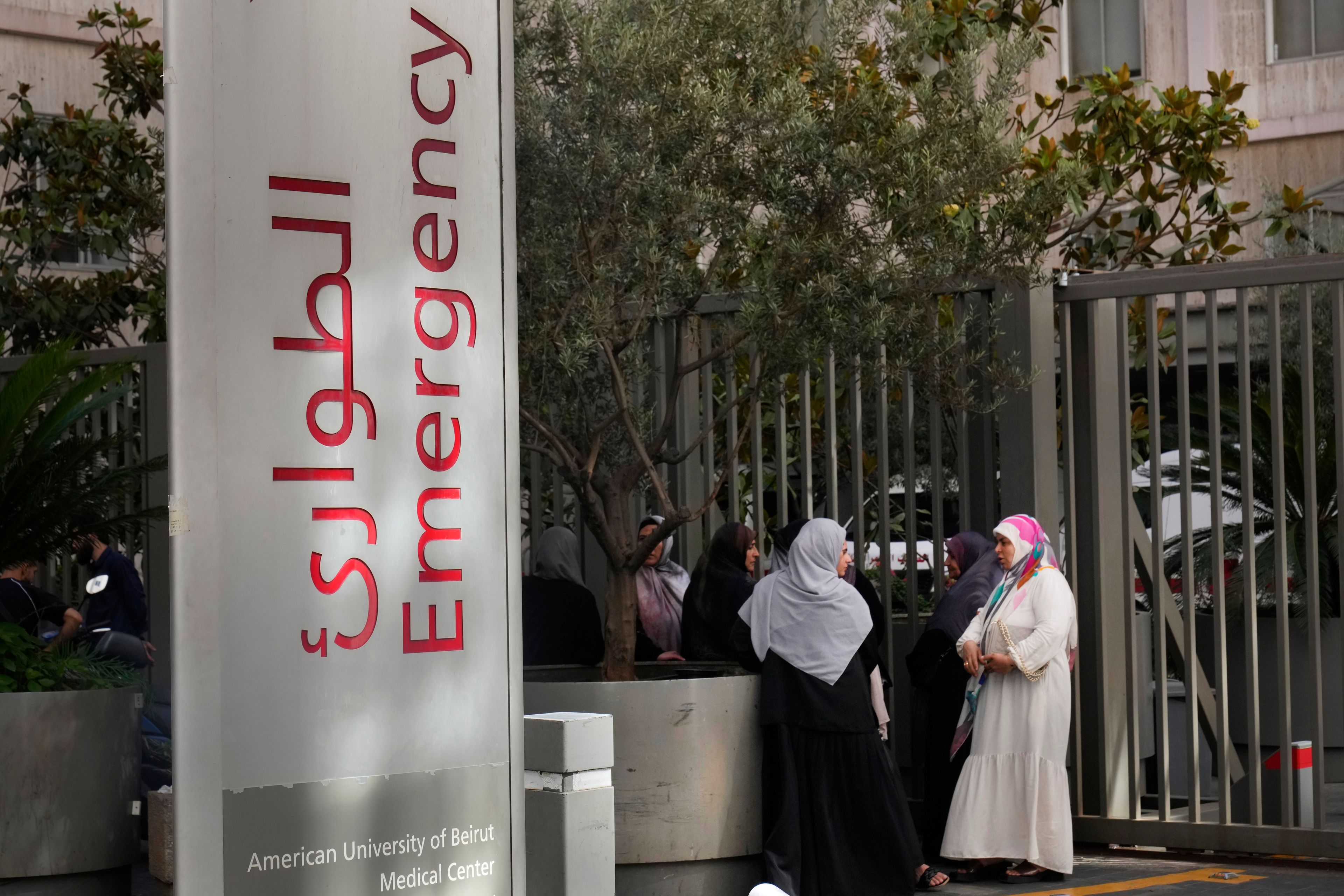 CORRECTS DAY TO TUESDAY WHEN INJURED Families of victims who were injured on Tuesday by their exploding handheld pagers, wait at the emergency entrance of the American University hospital, in Beirut, Lebanon, Wednesday, Sept. 18, 2024. (AP Photo/Hussein Malla)