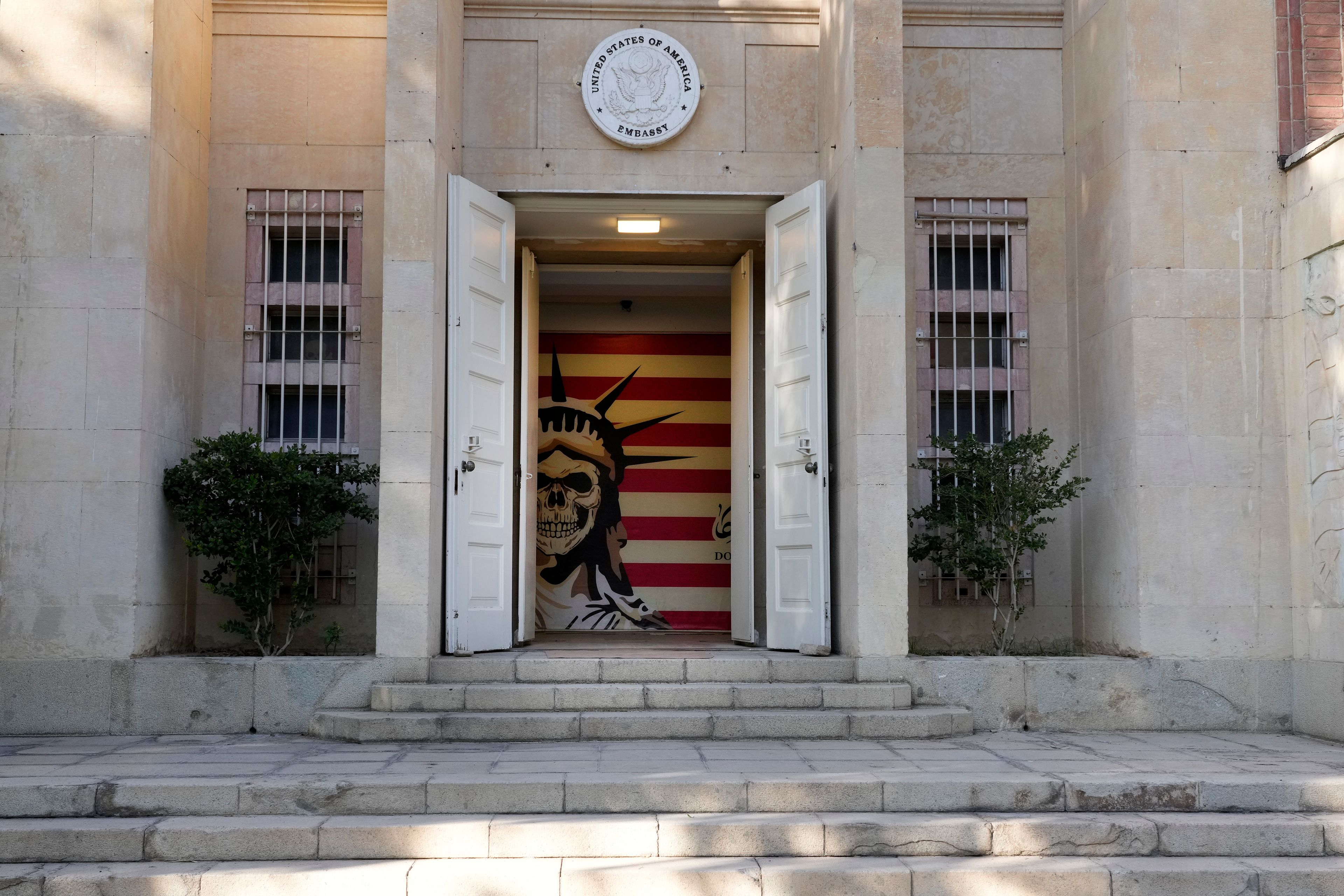 The entrance to the former U.S. Embassy, which has been turned into an anti-American museum, is seen with a satirised image of the Statue of Liberty and the U.S. flag in Tehran, Iran, Tuesday, Oct. 22, 2024. (AP Photo/Vahid Salemi)