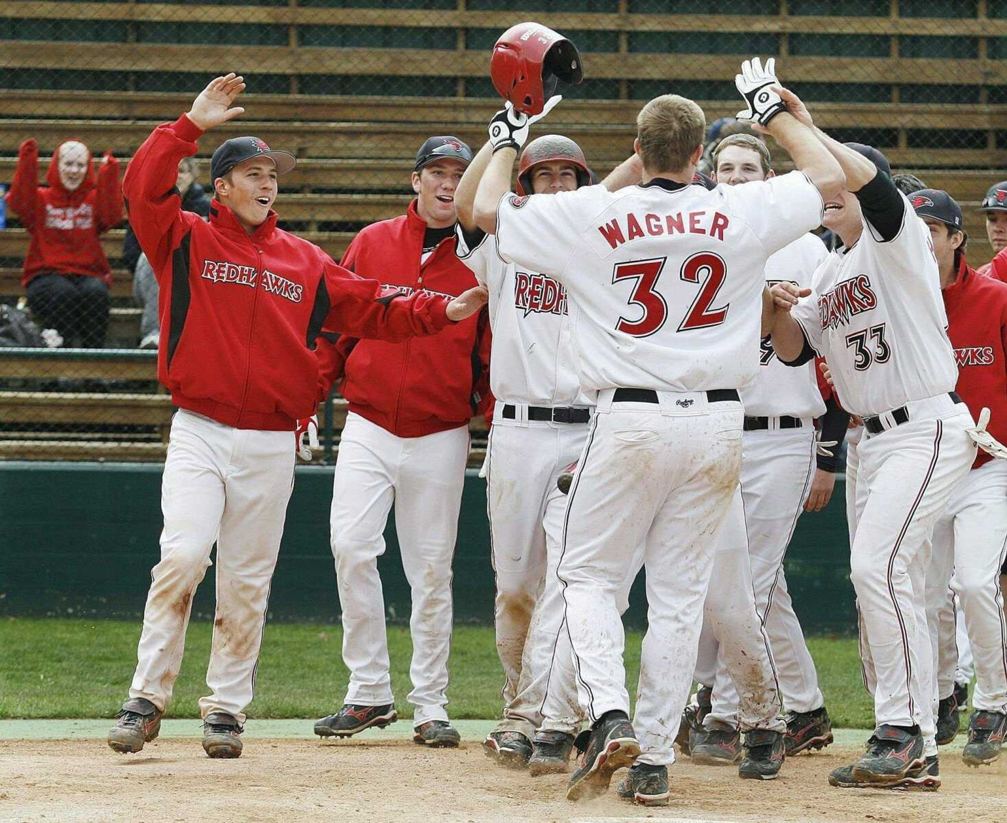 ELIZABETH DODD ~ edoddsemissourian.com<br>Southeast's Matt Wagner celebrates with his teammates after hitting the winning home run during the 10th inning of the first game Saturday at Capaha Field.