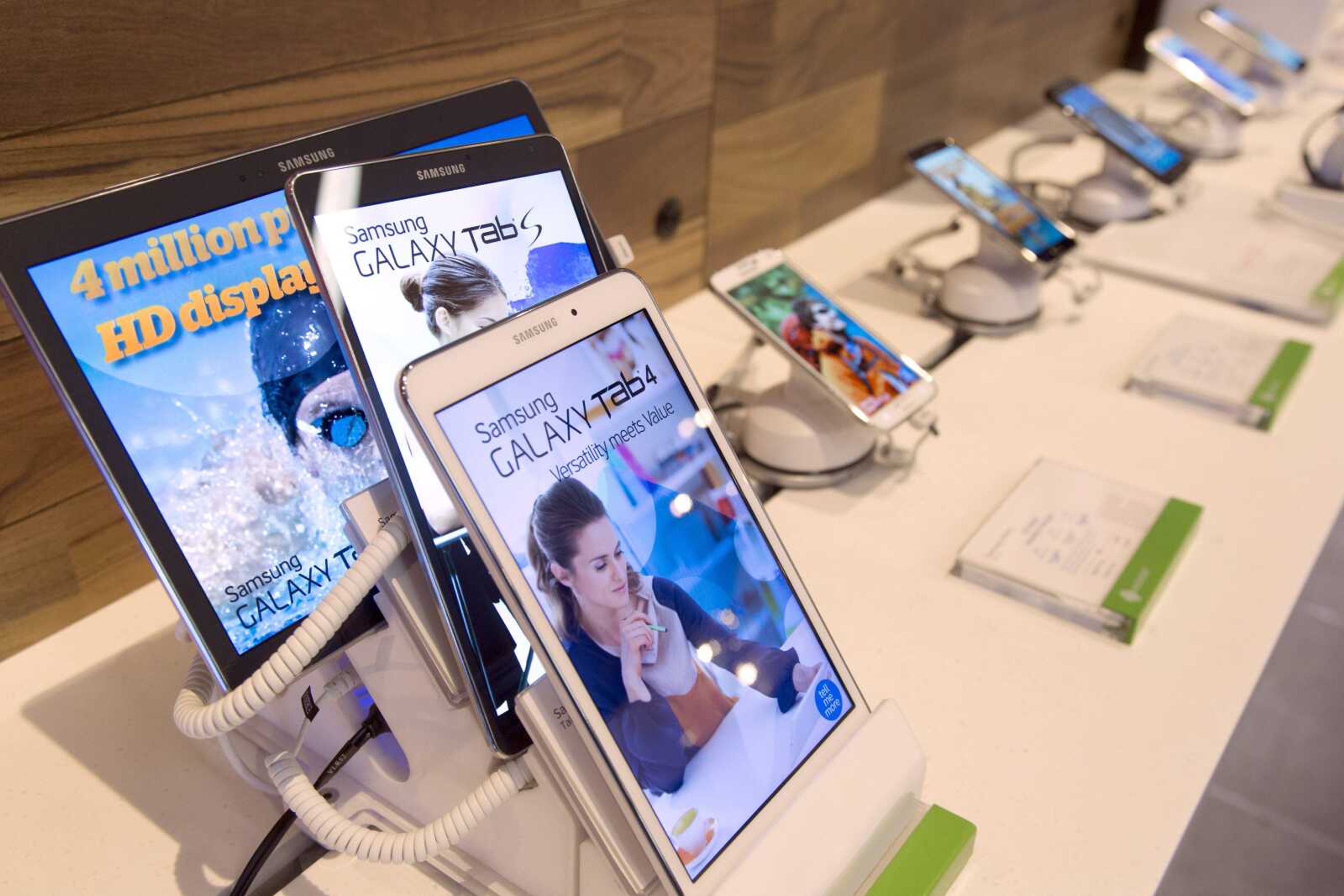 Samsung Galaxy tablets are displayed at an AT&T company store May 6 in New York. AT&T, whose slogan "Reach Out and Touch Someone" became popular in the 1980s, now wants to be on TVs, cars and even trashcans. (Mark Lennihan ~ Associated Press)