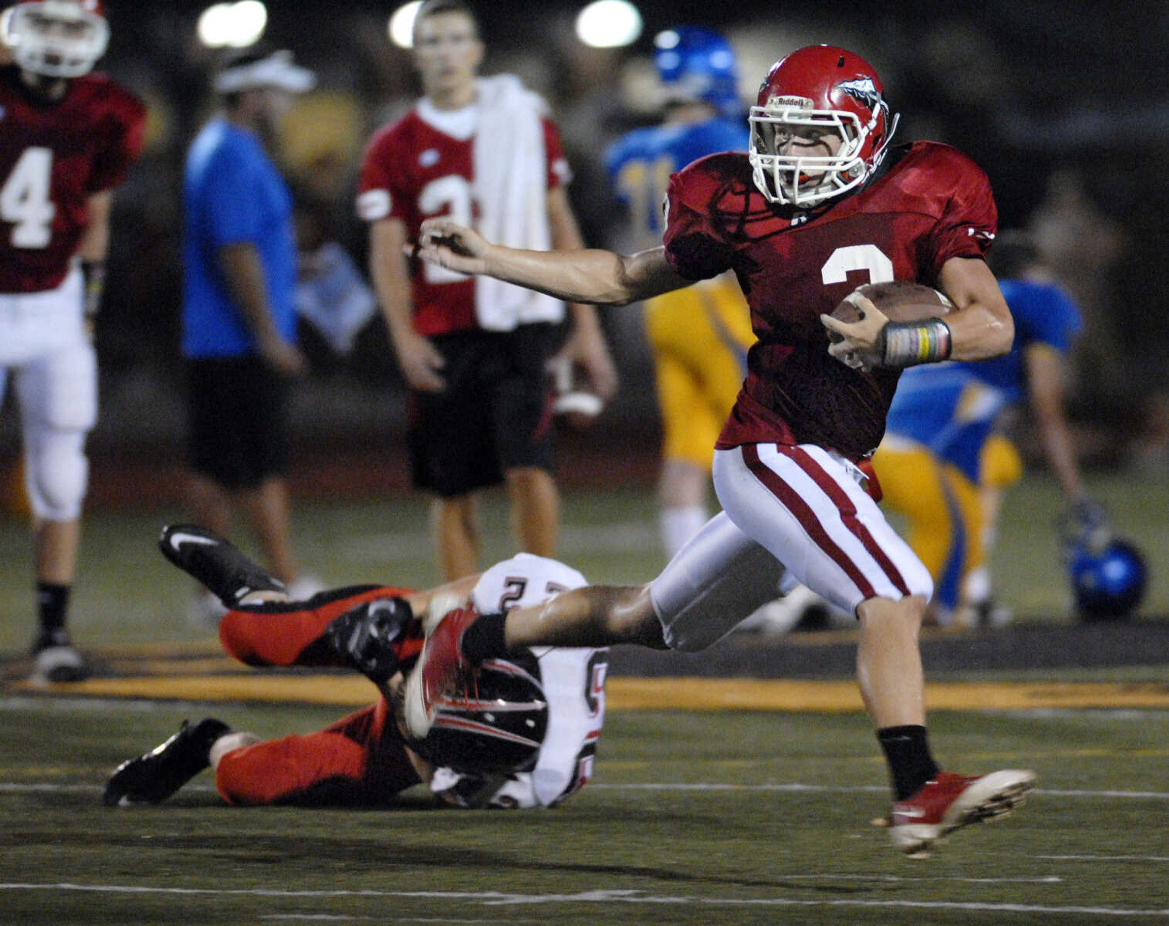 KRISTIN EBERTS ~ keberts@semissourian.com

Jackson's Ethan Ruch runs the ball after avoiding a tackle by Union's Trevor King, left, during a jamboree game on Friday, August 20, 2010, at Farmington High School.