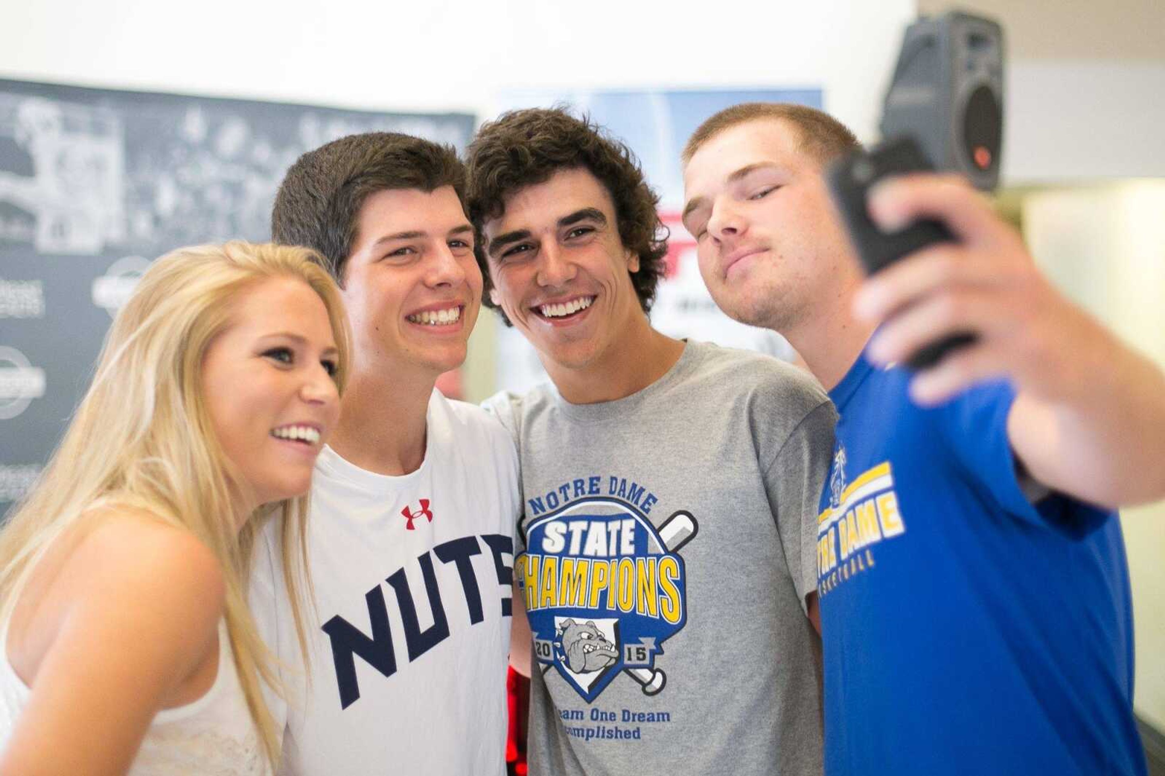 Notre Dame baseball players, Derek Hulshof, right, Adam Pope and Chase Urhahn take a photo with Semoball Awards intern Whitney Welker at the Semoball Awards spring sports selection show at First Midwest Bank Saturday, June 13, 2015 in Cape Girardeau. (Glenn Landberg)