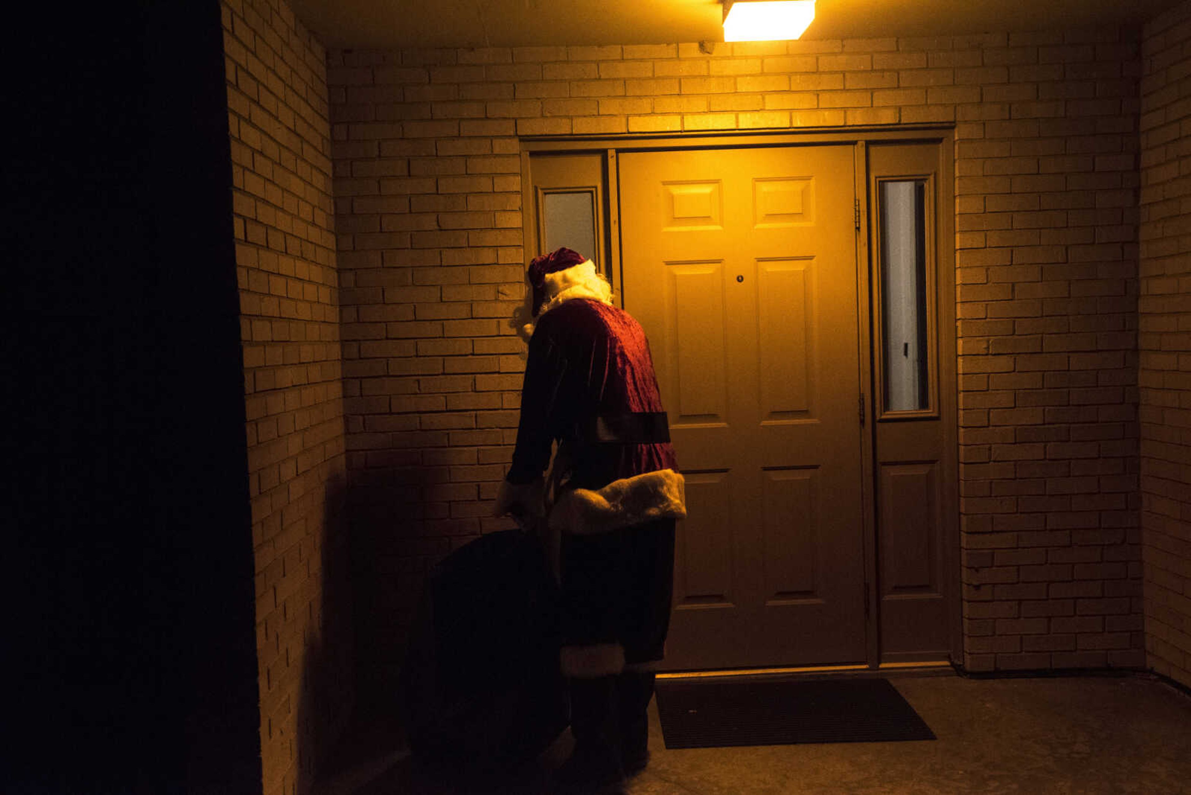 Charlie Wirtle as Santa deliveries presents to kids during the Jaycee Toybox delivery on Thursday, Dec. 22, 2016, in Cape Girardeau.