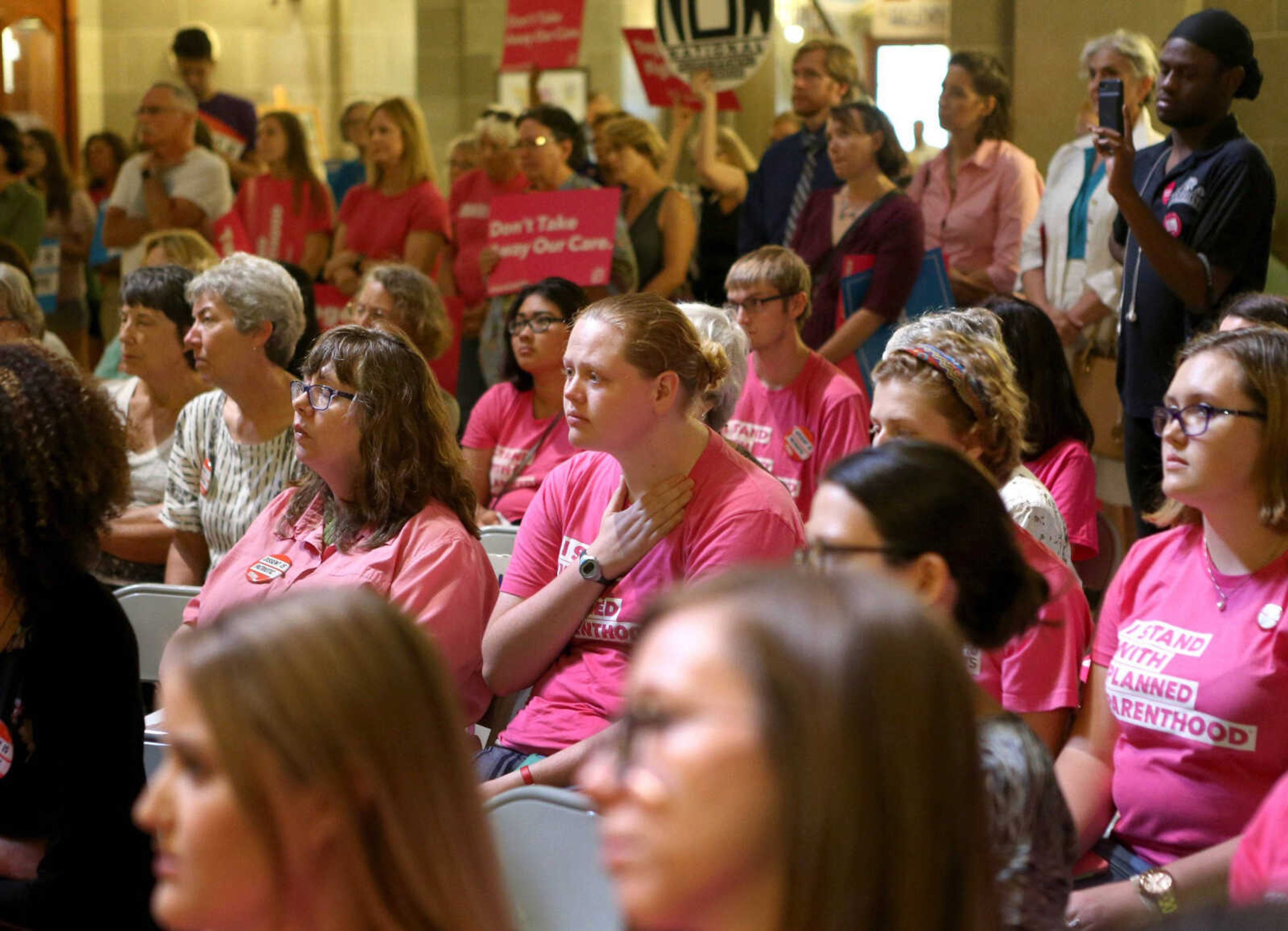 Annesley Clark, center, of St. Louis listens to a speech as abortion-rights supporters gather in the rotunda of the Missouri Statehouse during a rally held by NARAL on Wednesday.