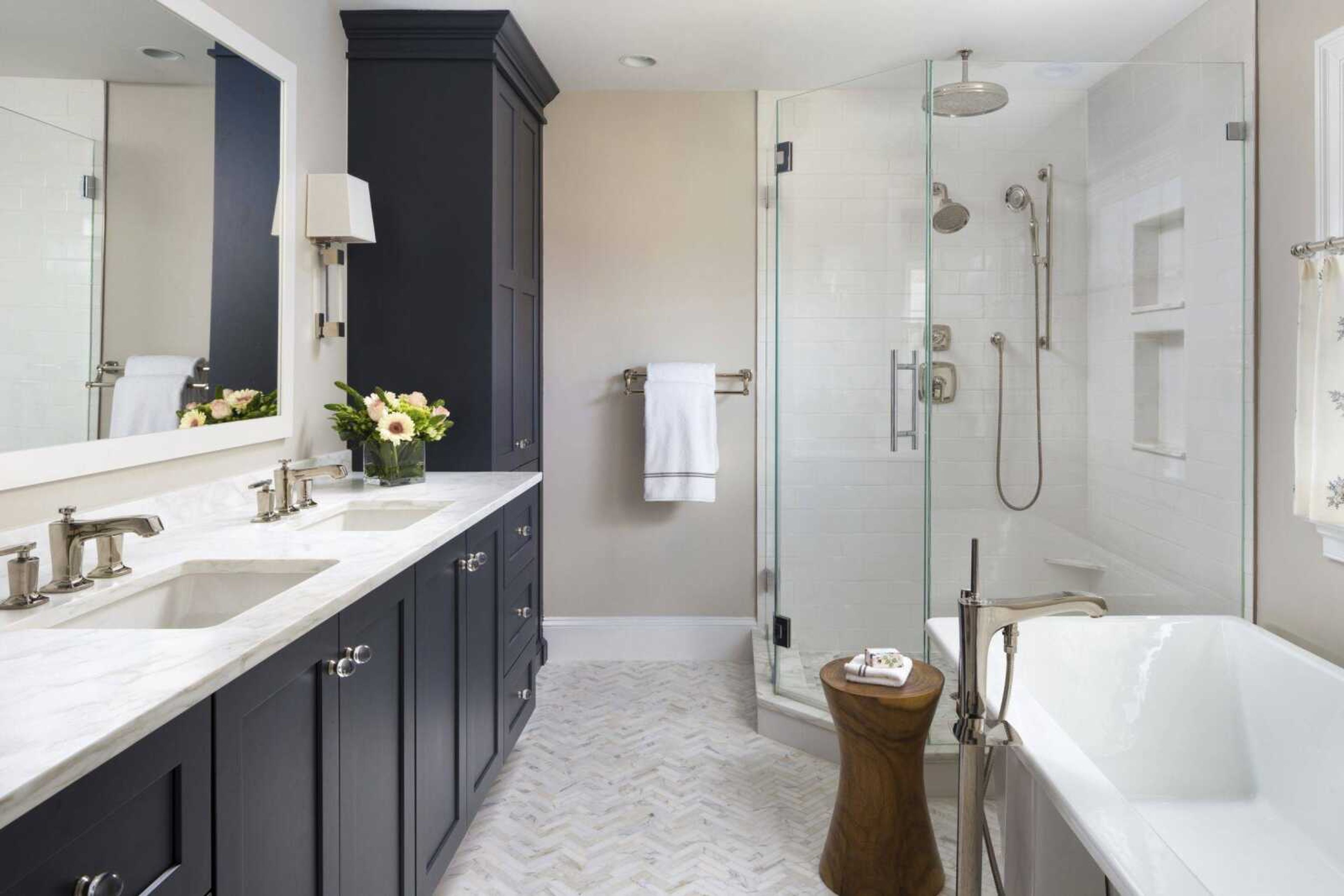 This photo shows a freestanding bathtub, as seen in this Chevy Chase, Maryland, master bathroom by Aidan Design, is much more popular than the built-in bathtubs that have been used in residential bath design for decades, says designer Nadia Subaran. Beyond their practical use, tubs like this serve as sculptural design pieces in a beautiful master bathroom.