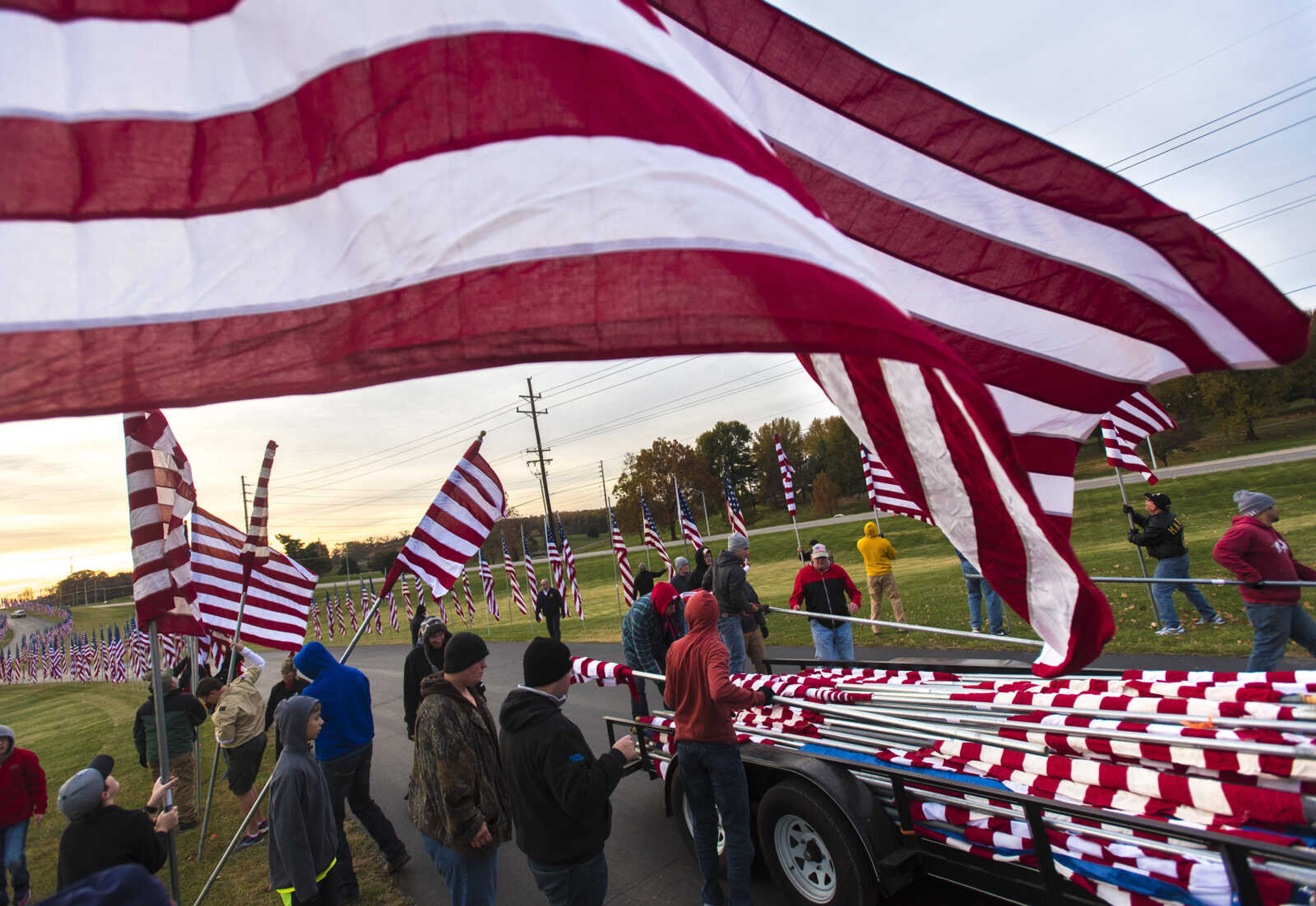 Volunteers set up flags in Cape County Park North during Veterans Day, Saturday, Nov. 11, 2017 in Cape Girardeau.