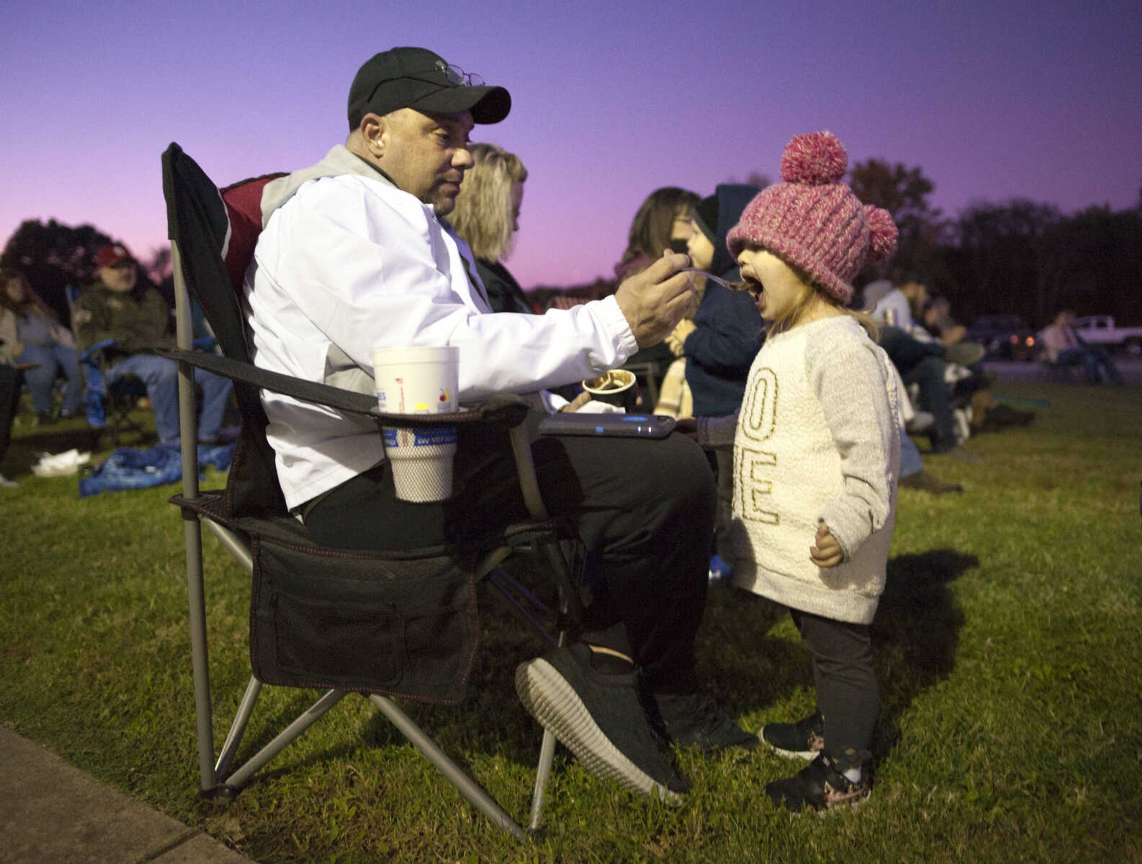 Larry Craft feeds a scoop of chocolate ice cream to 2-year-old Jo Dooley during a community worship event Sunday evening, Oct. 13, 2019, at Crossroads Church in Jackson.