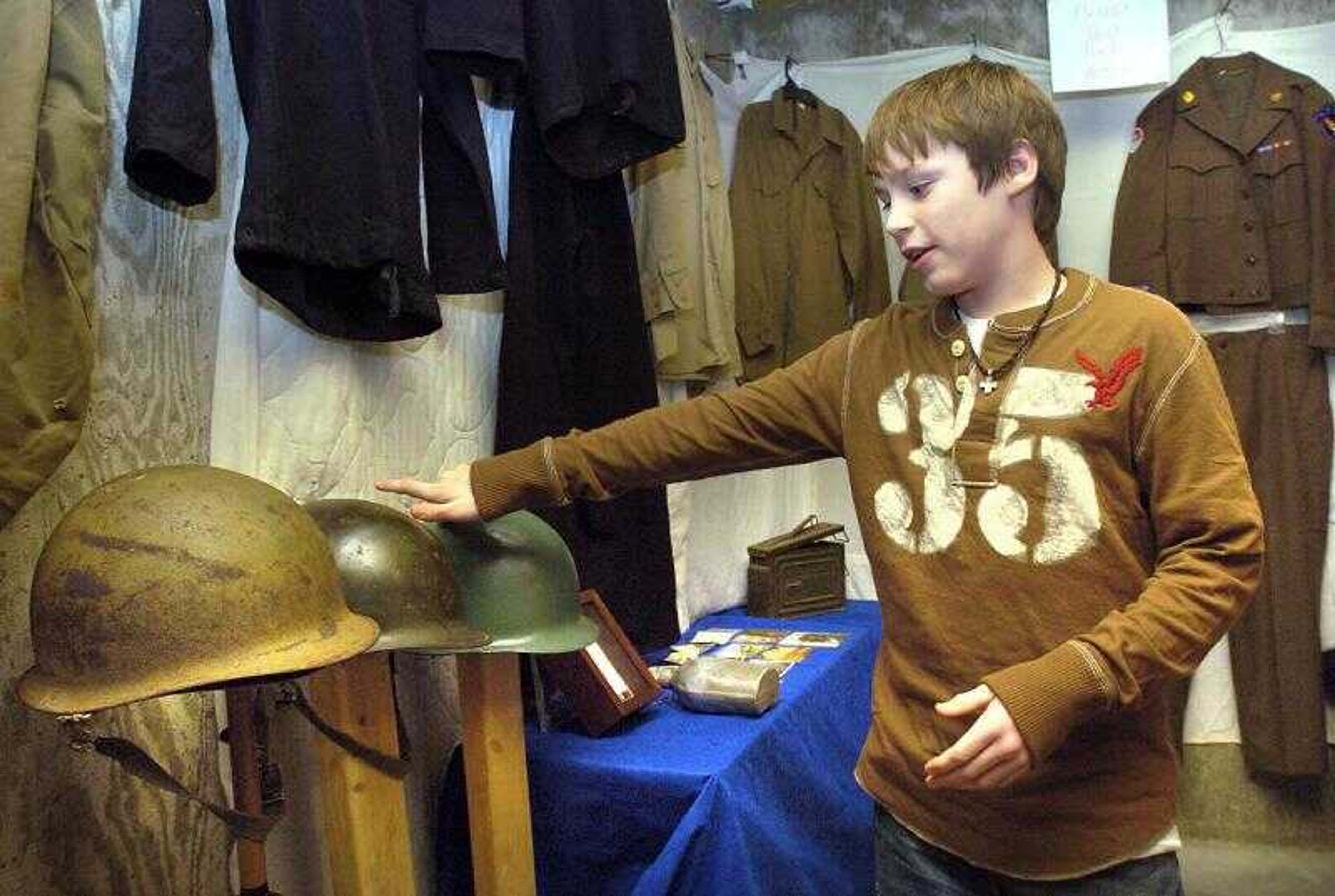 Alex Schlitt of Oran, Mo., discussed his collection of World War II collectibles displayed in his basement museum Wednesday. He has been collecting for about two years. (Fred Lynch)