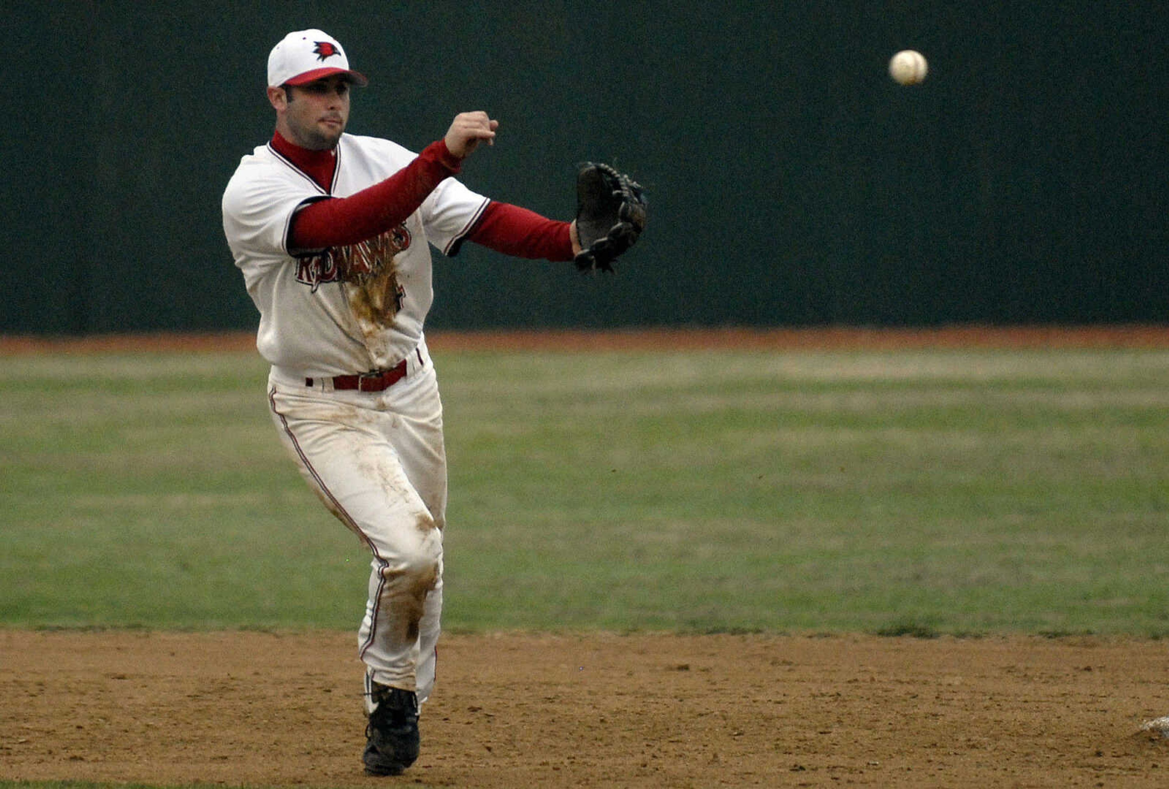 LAURA SIMON~lsimon@semissourian.com
Southeast junior Kenton Parmley tosses the ball to first in the third inning Ball State Sunday, February 27, 2011 at Capaha Field. Southeast defeated Ball State 22-8.