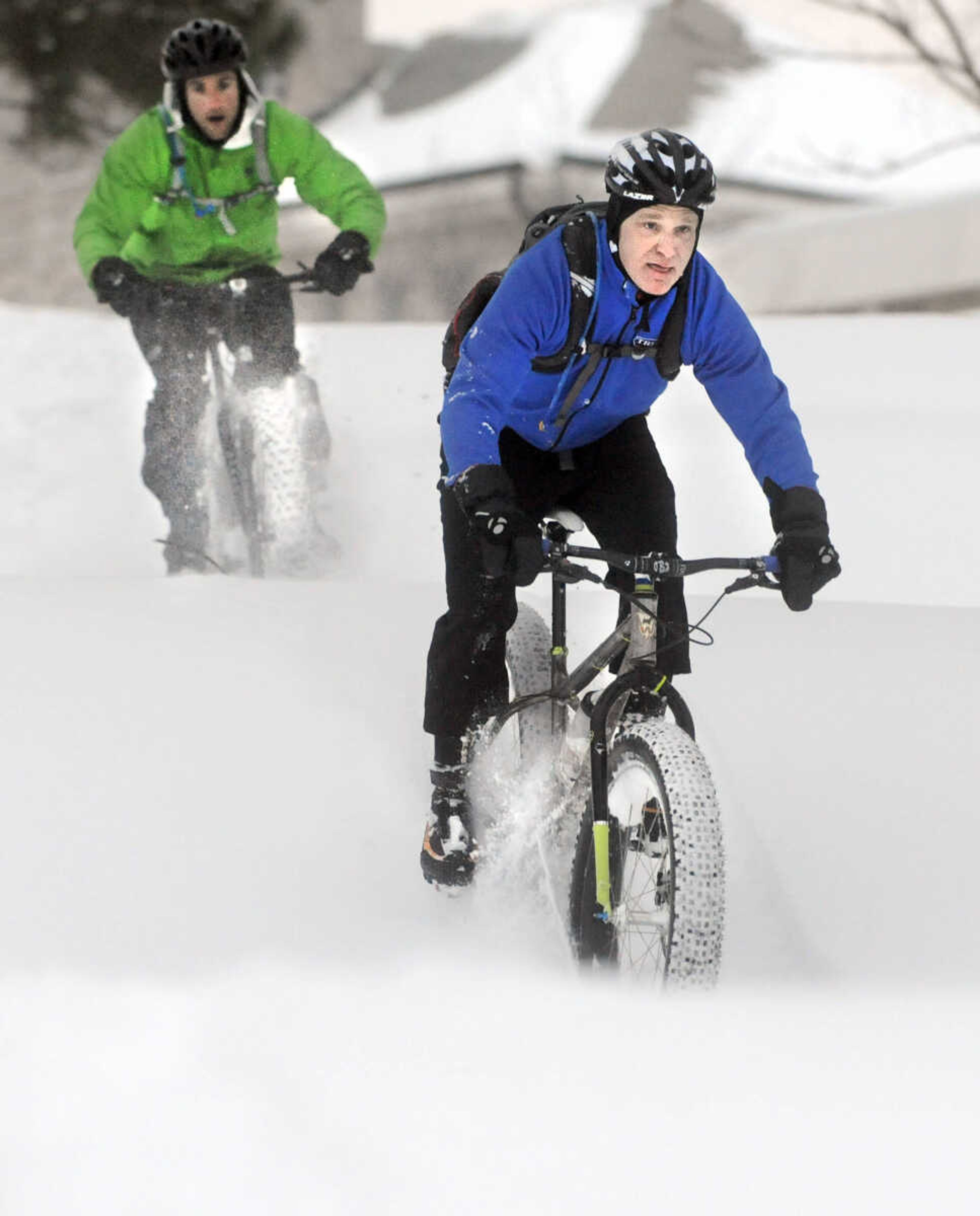 LAURA SIMON ~ lsimon@semissourian.com

John Dodd, front, and Tim Vollink ride fat bikes through the snow on the terraces outside Academic Hall Tuesday evening, Feb. 17, 2015.