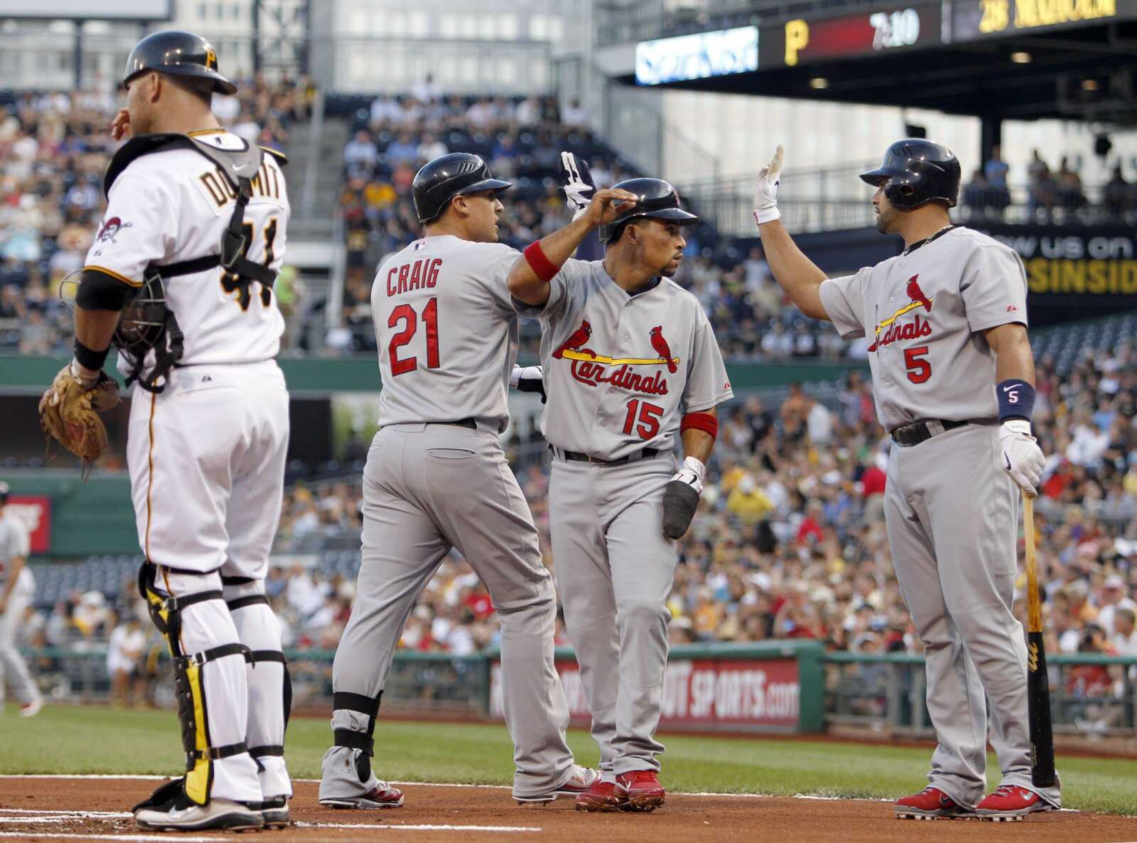 Cardinals outfielder Allen Craig is greeted at home plate by teammates Rafael Furcal and Albert Pujols, right, after Craig hit a two-run home run during the first inning Wednesday in Pittsburgh. (KEITH SRAKOCIC ~ Associated Press)