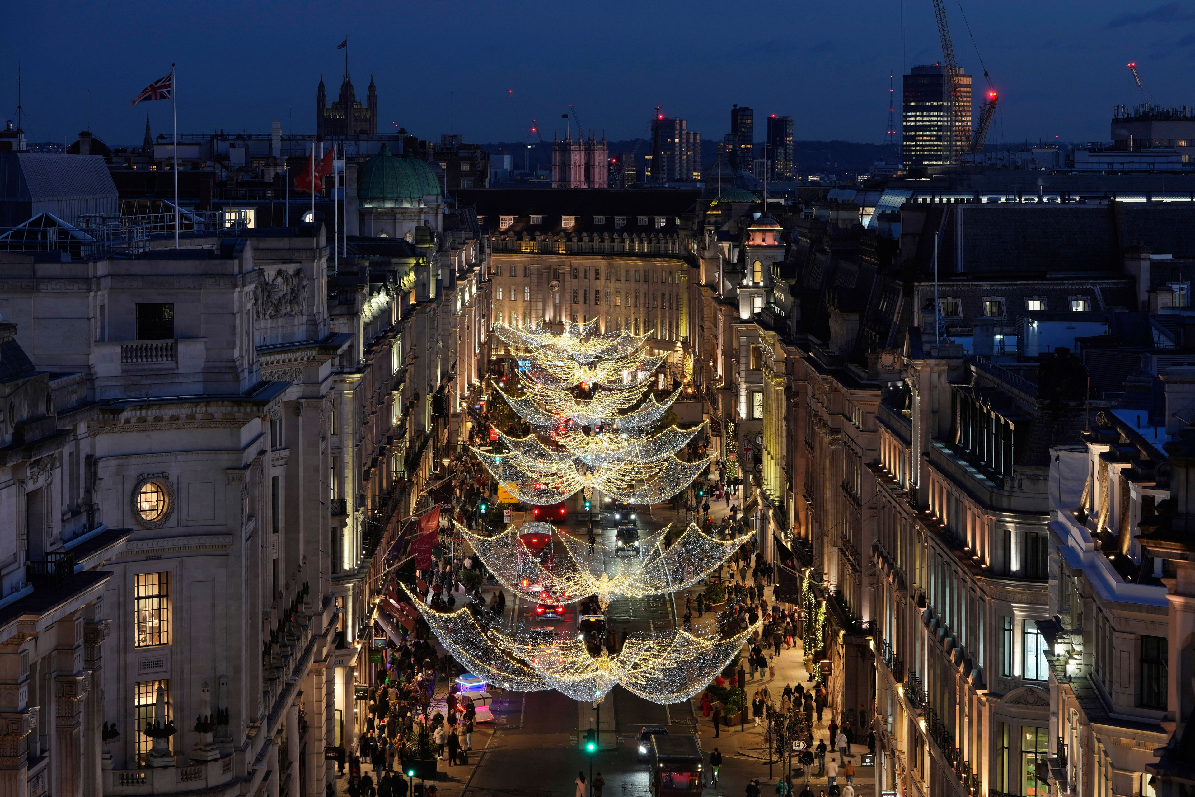 Christmas lights are displayed on Regent Street, in London, Wednesday, Nov. 20, 2024. (AP Photo/Kin Cheung)