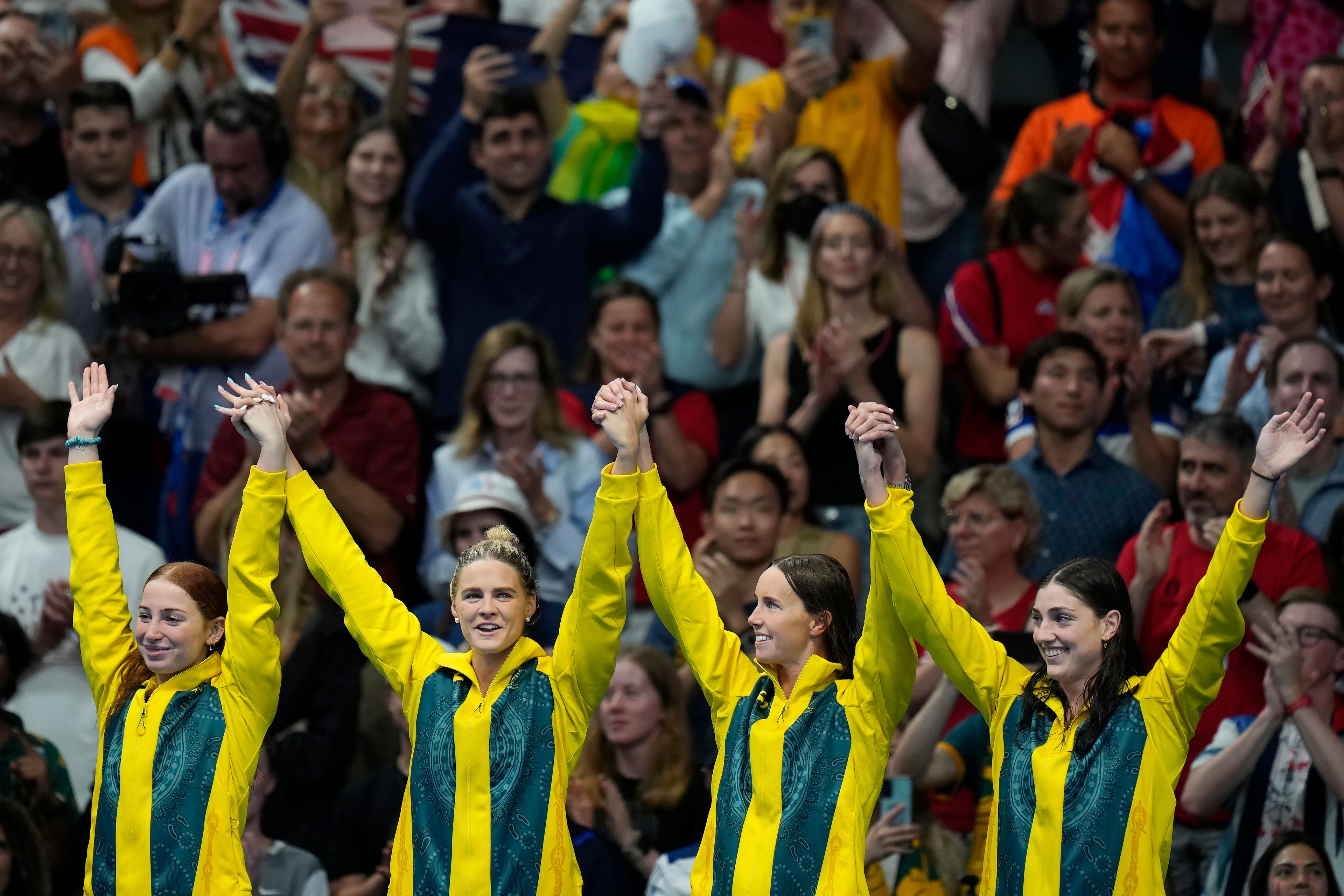 FILE _ Australia's Mollie O'Callaghan, Shayna Jack, Emma McKeon and Meg Harris, from left, celebrate on the podium after winning the women's 4x100-meter freestyle relay final at the 2024 Summer Olympics, Saturday, July 27, 2024, in Nanterre, France. (AP Photo/Petr David Josek, File)