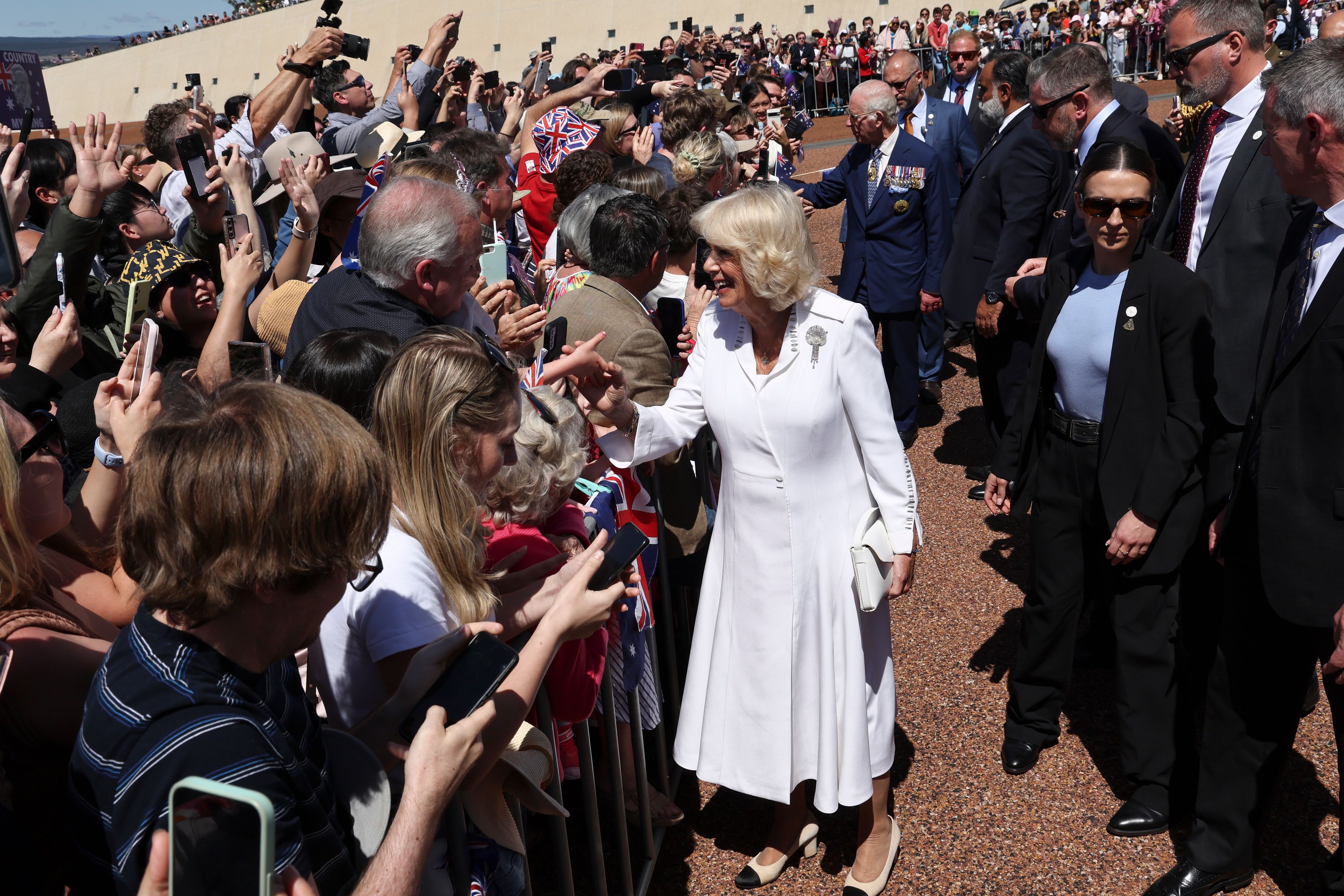 Britain's Queen Camilla, front, and King Charles III greet members of the public outside Parliament House in Canberra, Australia, Monday, Oct. 21, 2024. (David Gray/Pool Photo via AP)