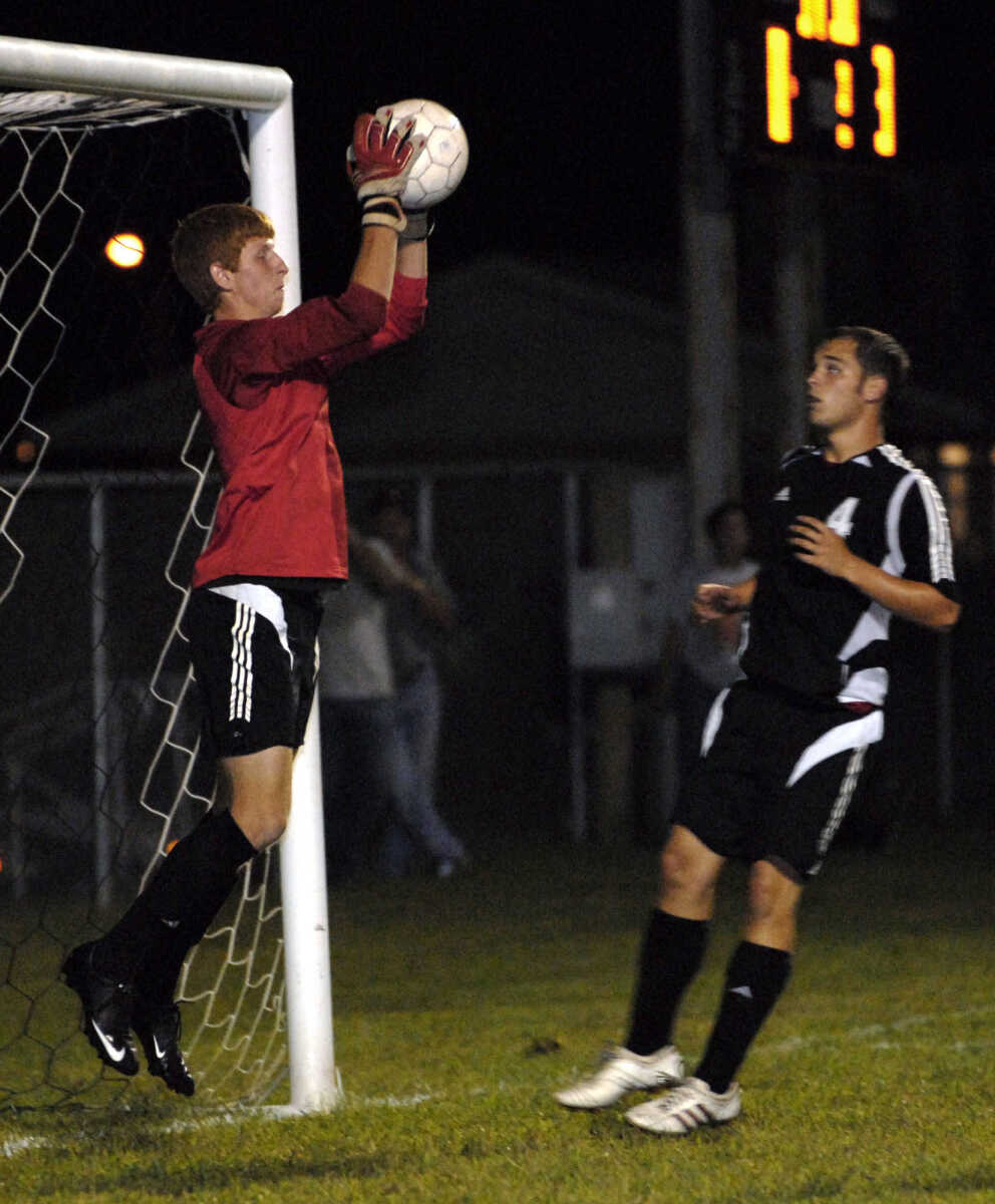 FRED LYNCH ~ flynch@semissourian.com
Jackson goalkeeper Cody Boehme saves a Central goal as teammate Corey Baker looks on during second half Tuesday at Central.