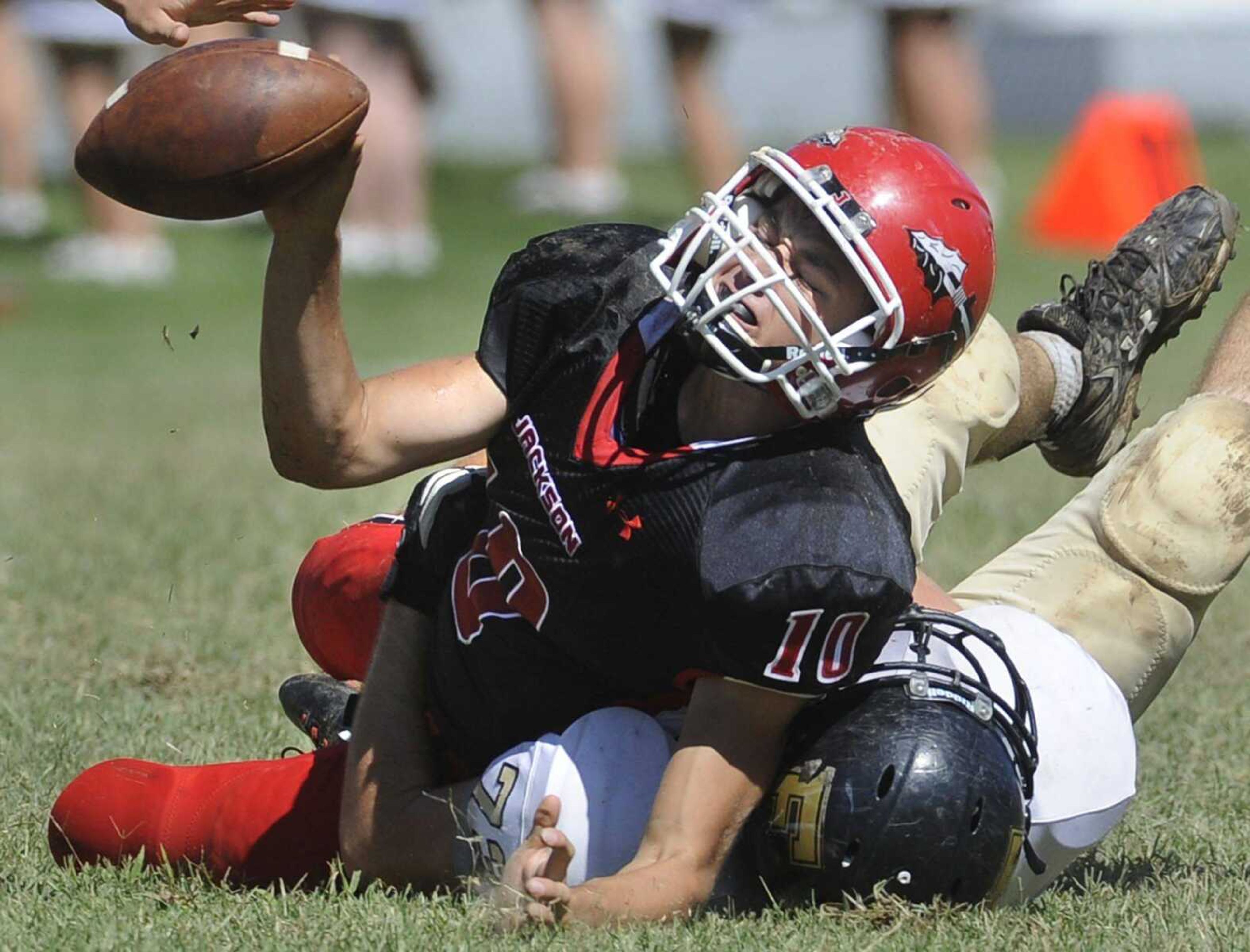 Jackson quarterback Ty Selsor is brought down by Farmington's Austin Herbst during the first quarter Saturday, Sept. 8, 2012 at Jackson High School. (Fred Lynch)