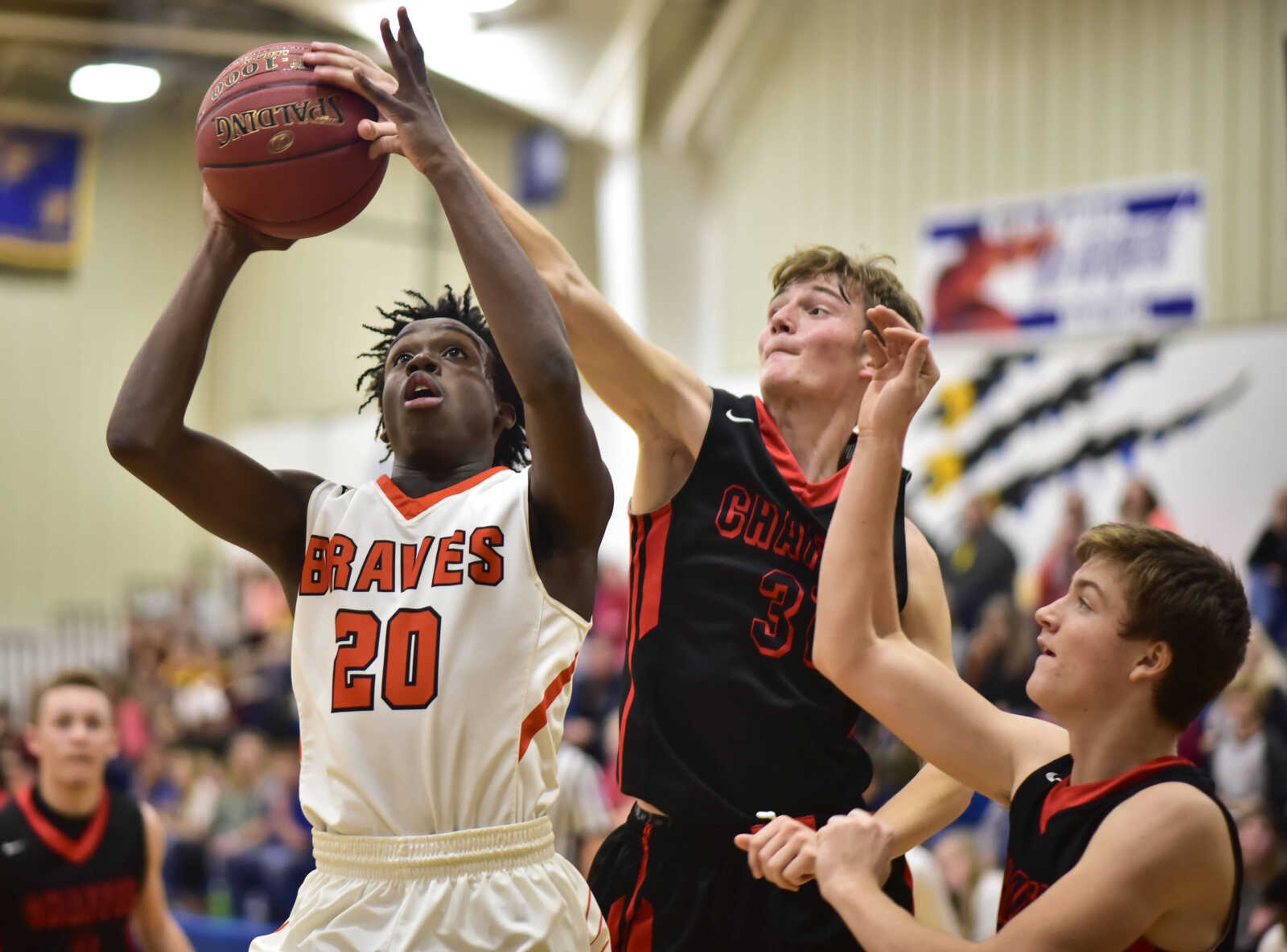 Chaffee senior Alec Bogenpohl, center, blocks a layup shot by Scott County Central sophomore Keshawn Sanders, left, during a quarterfinal game Tuesday, Nov. 28, 2017, in the Oran Invitational tournament at Oran High School.